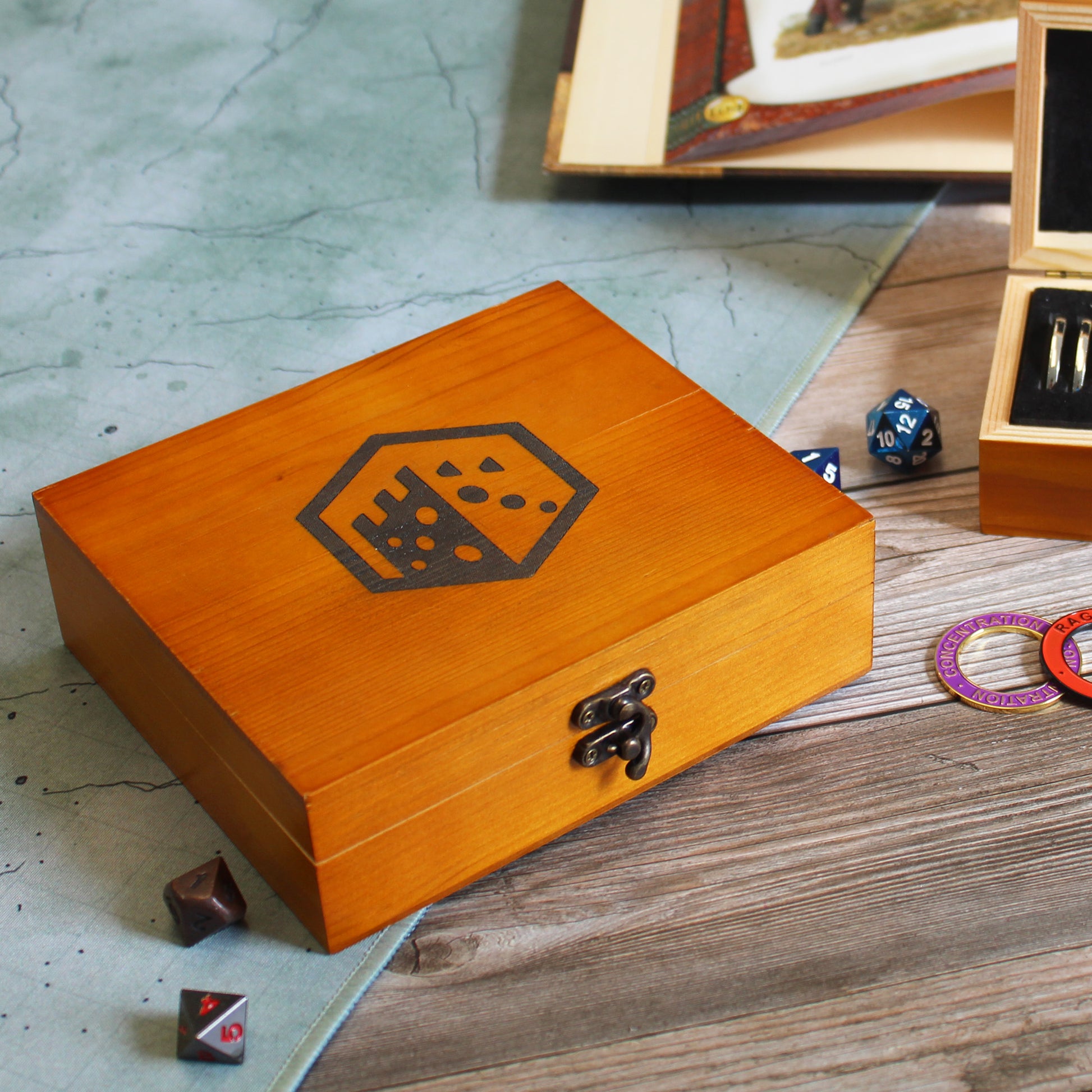 Closed Condition Ring Storage Box featuring the Dice Dungeons logo on top, made from pine wood for secure storage.