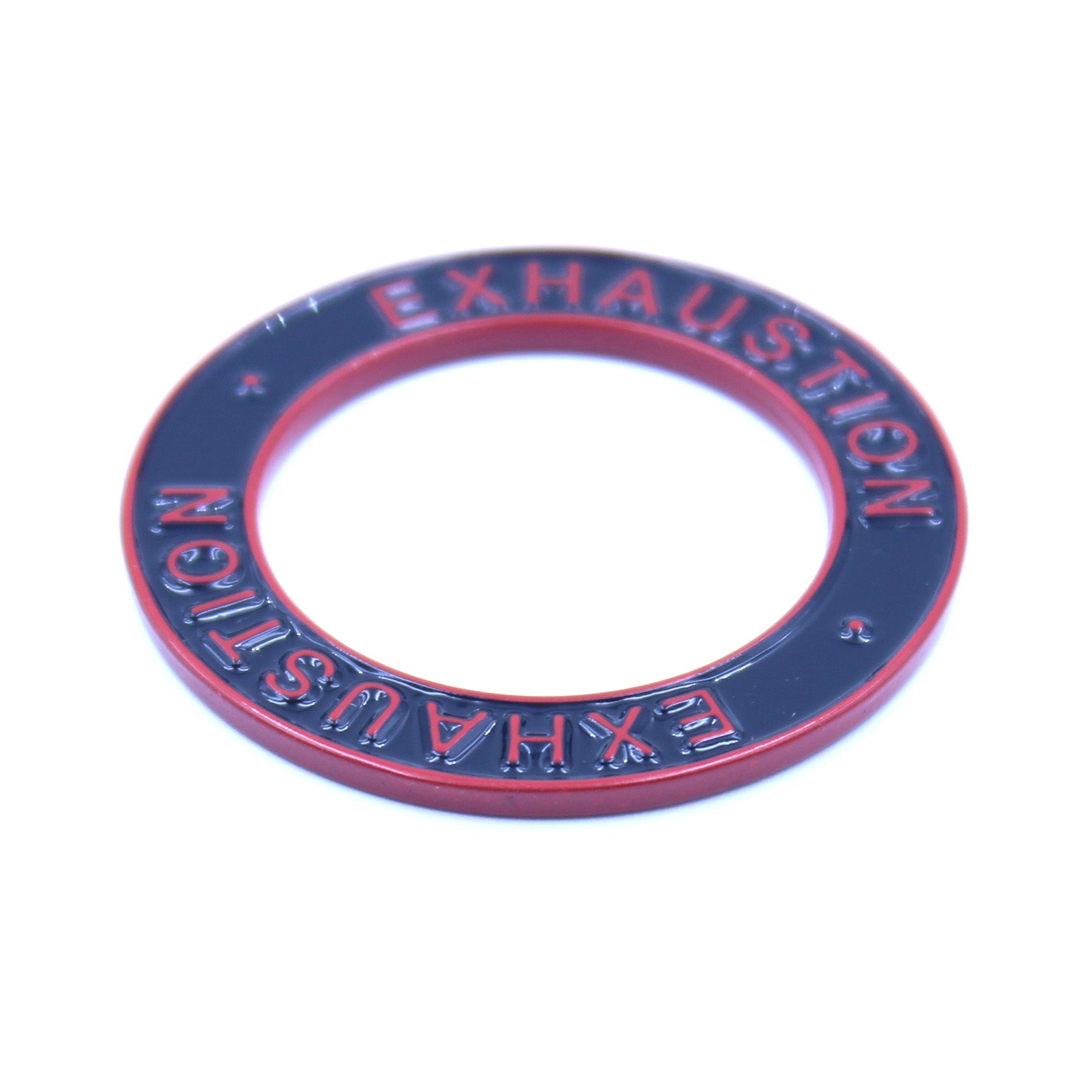 Closeup of a black ring with a red rim and red text that says "Exhaustion" on it