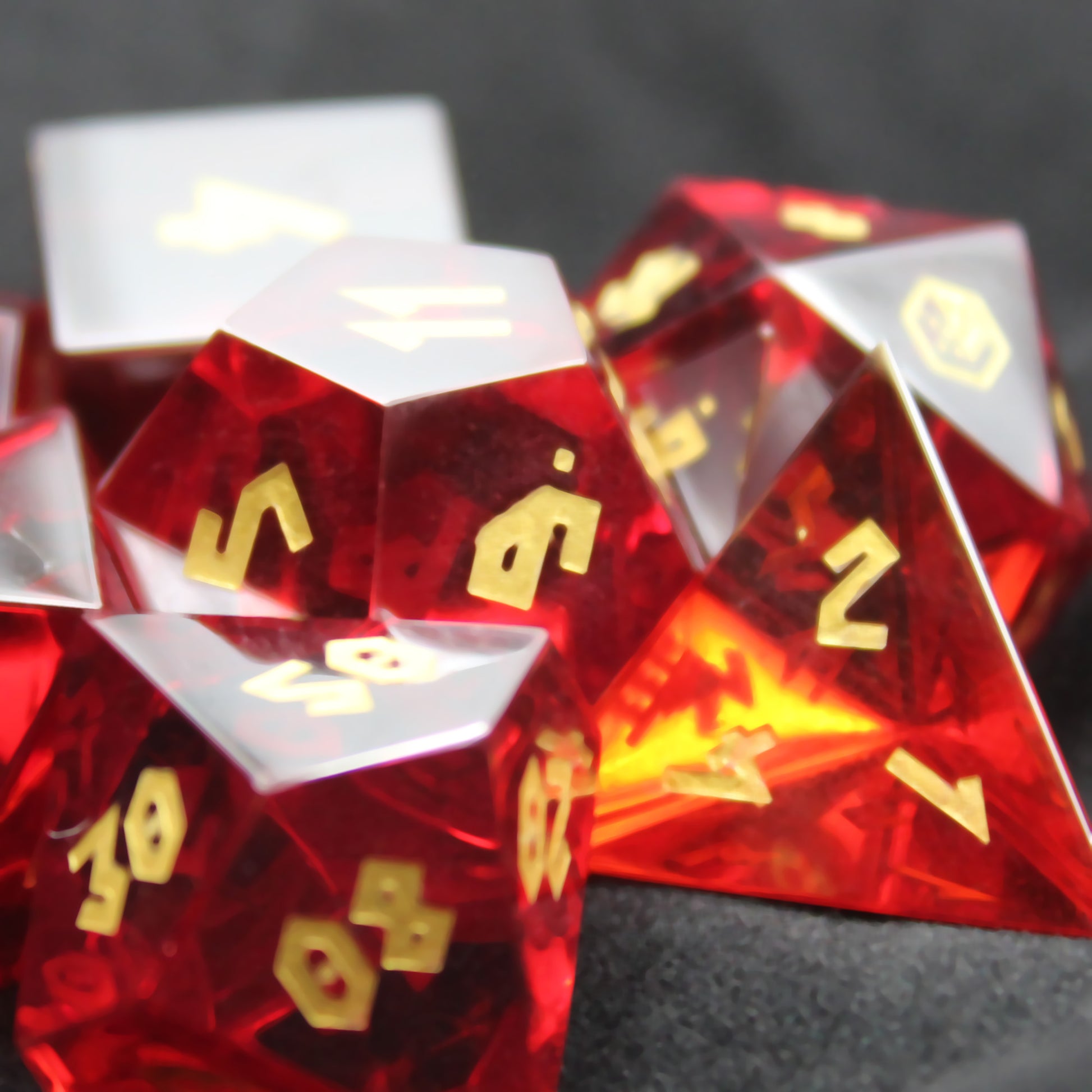 Close-up of Red Cubic Zirconia dice with light shining through, showing the translucent red color.