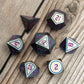 metal dungeons and dragons or starfinder dice on wooden table.