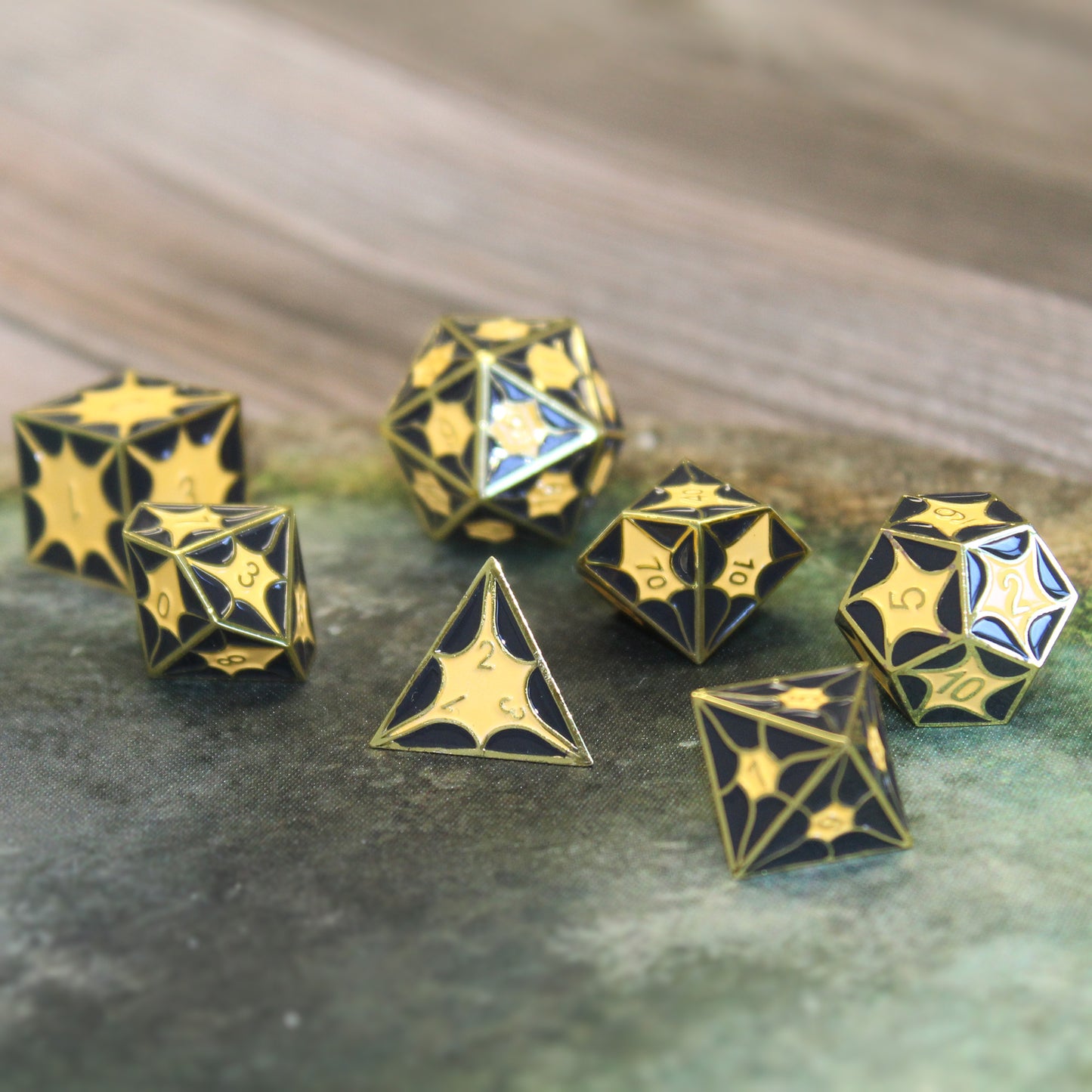 Metal dragon dice set on a game table, perfect for Dungeons and Dragons and other tabletop RPGs.