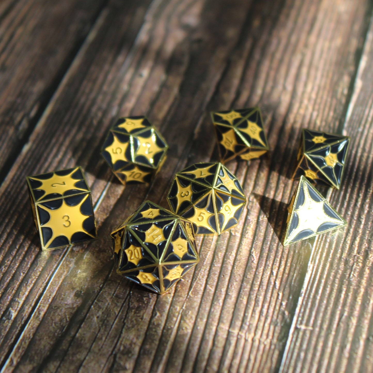 Black metal dice set with dragon pattern arranged on a table, exhibiting the ancient dragon scales ideal for DnD.
