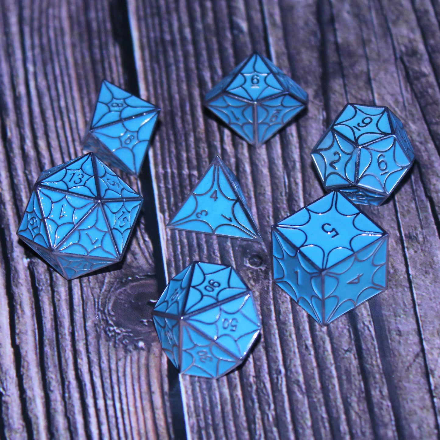 Glow-in-the-dark faerie dragon dice set displayed, perfect for tabletop RPGs like Dungeons and Dragons.