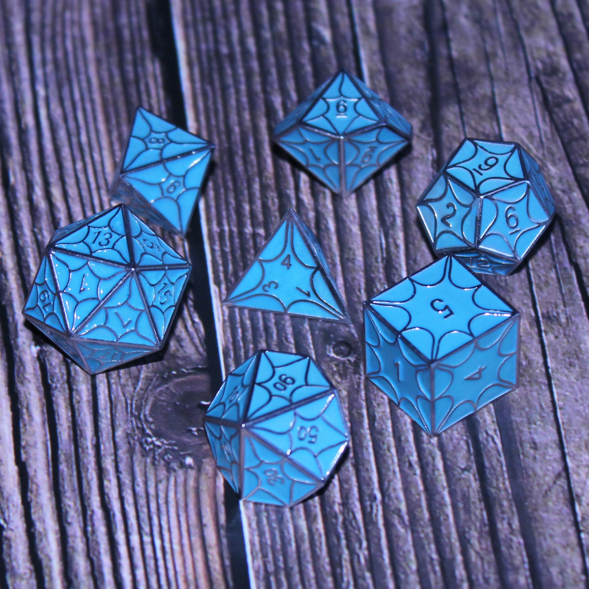 Glow-in-the-dark faerie dragon dice set displayed, perfect for tabletop RPGs like Dungeons and Dragons.