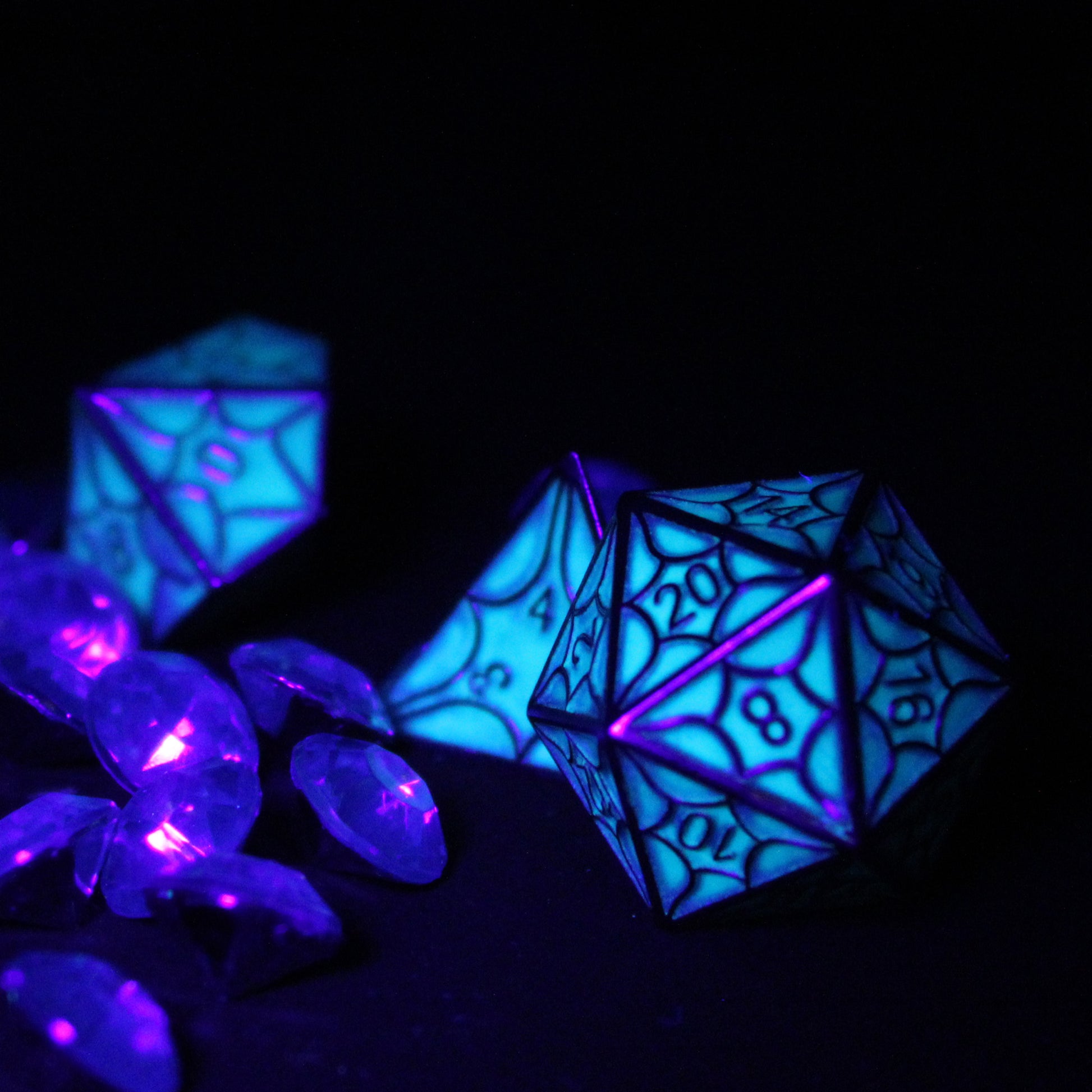 Glow-in-the-dark faerie dragon dice set illuminated in the dark, ideal for tabletop RPGs like DnD.