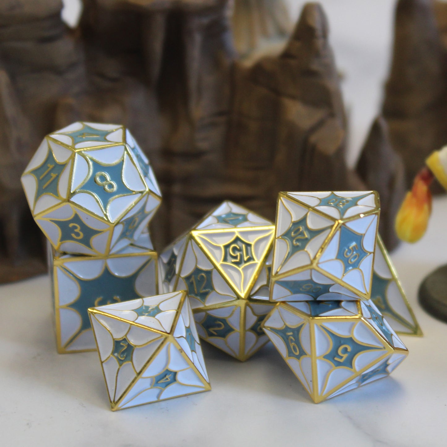 Full set of Metal DragonScale White Dice stacked before a stone background, perfect for DnD and tabletop RPGs.