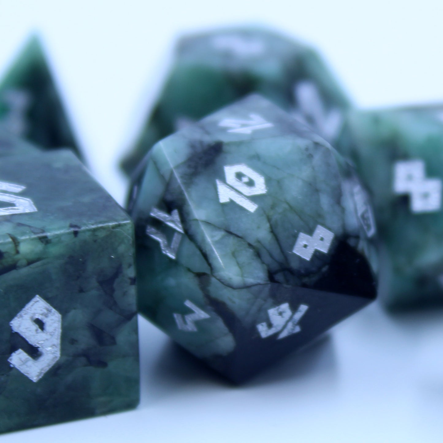 Close-up of the Emerald D20, showcasing the rich green gemstone and silver Roman-style numbering, perfect for Dungeons & Dragons and other RPGs.