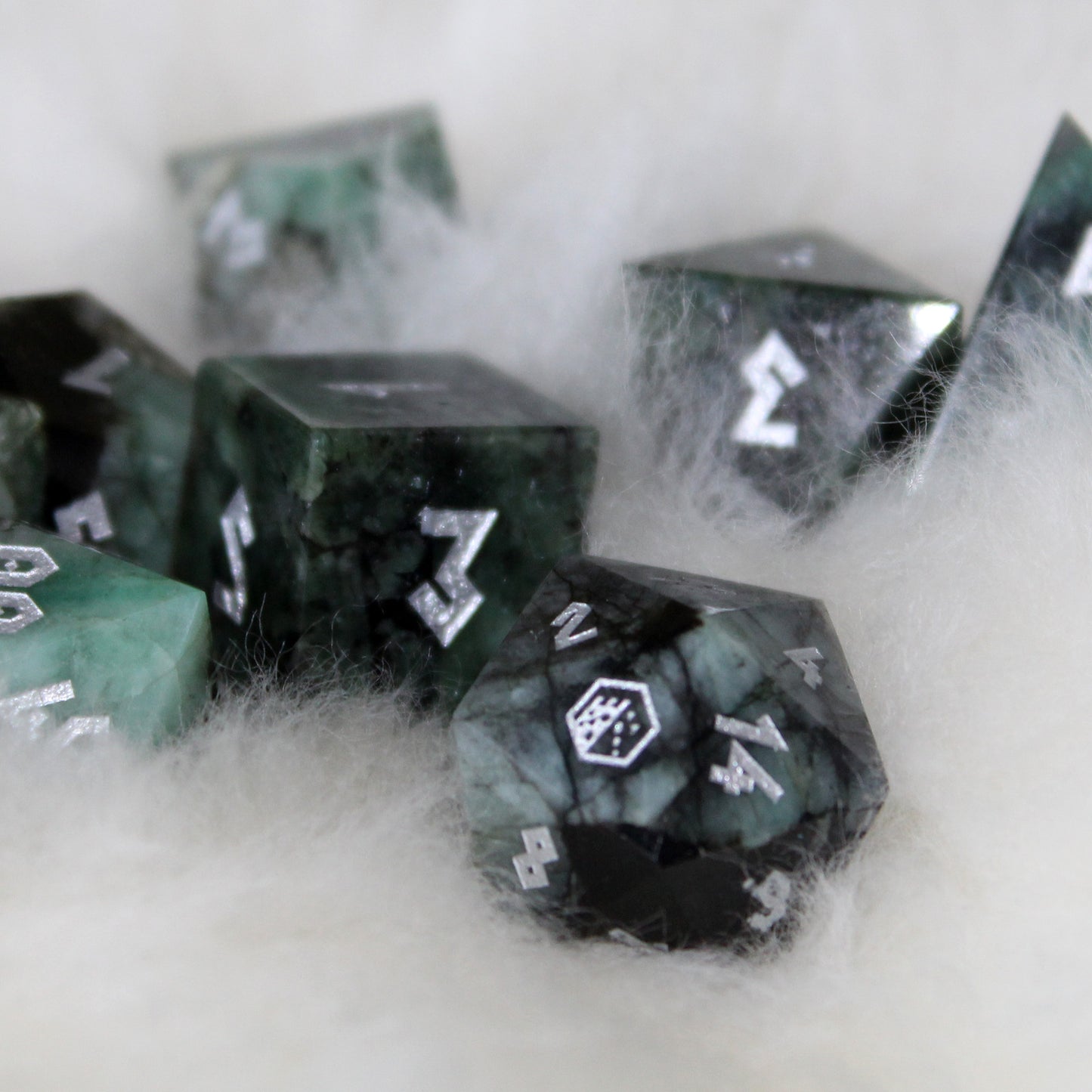 Real emerald gemstone dice set with silver inking, ideal for high-end TTRPG collections and die collectors.