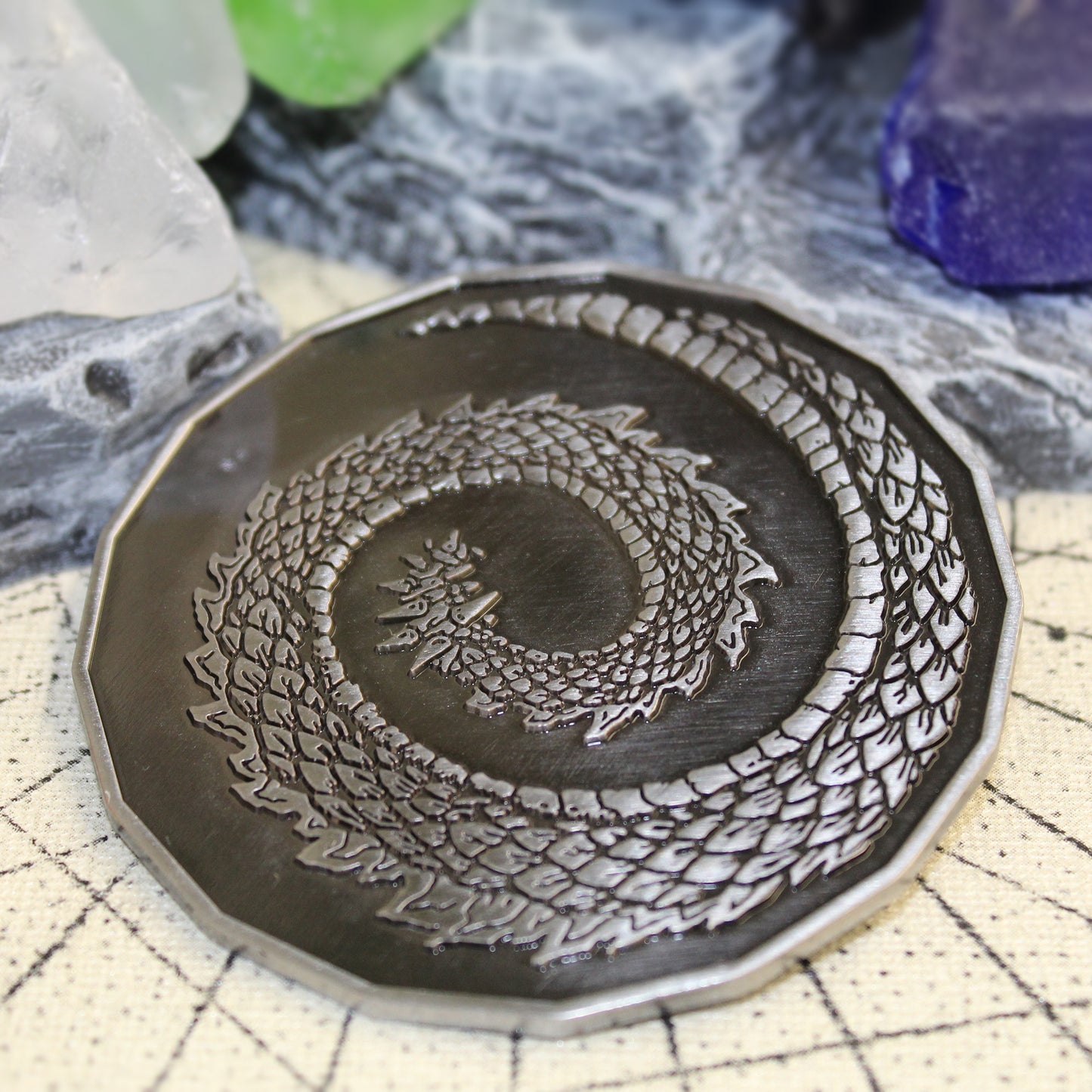 Back view of a 3 inch dragon token on a dnd tabletop.