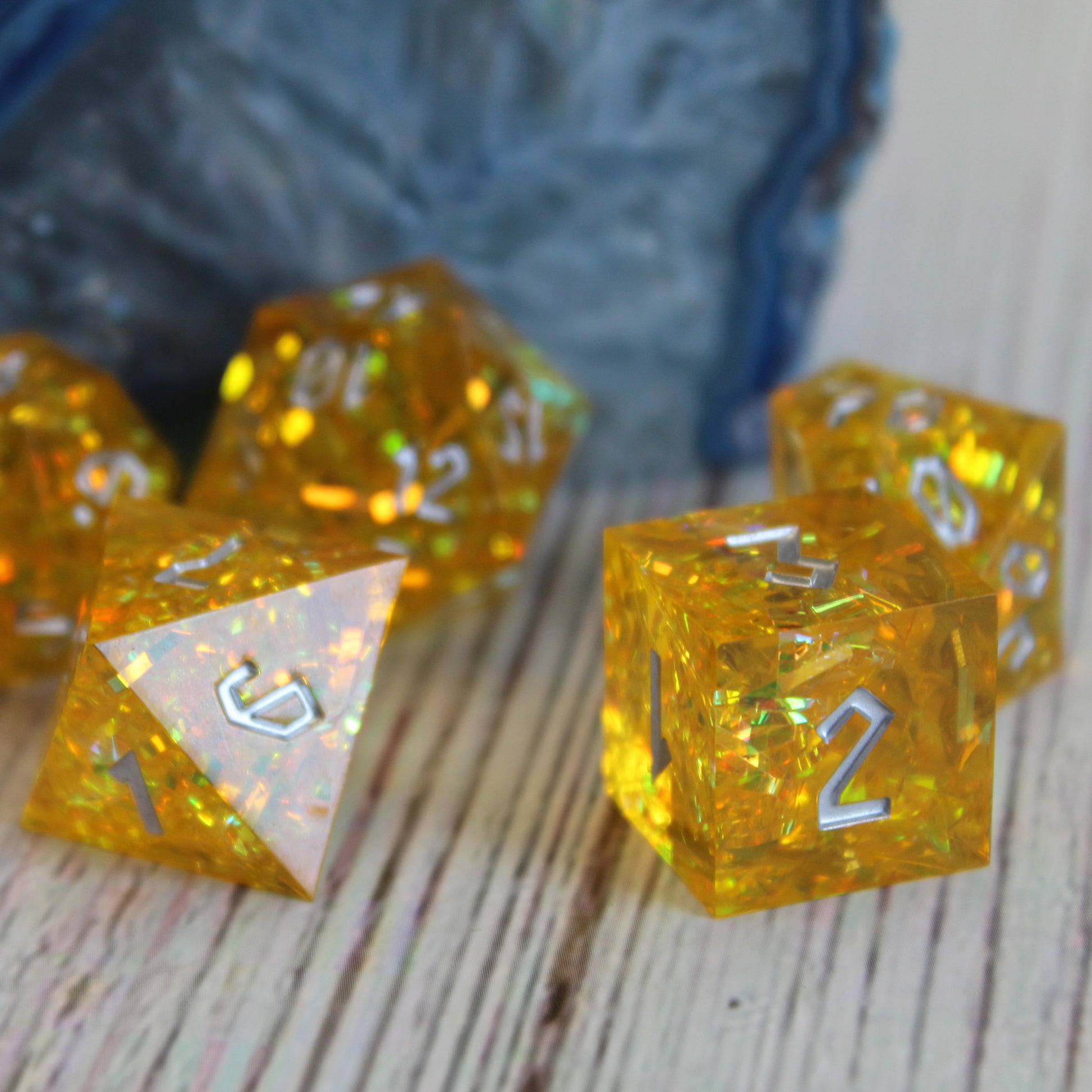 Close-up of the StarGlow Yellow D6, focusing on the sharp edges and the shimmers of color.