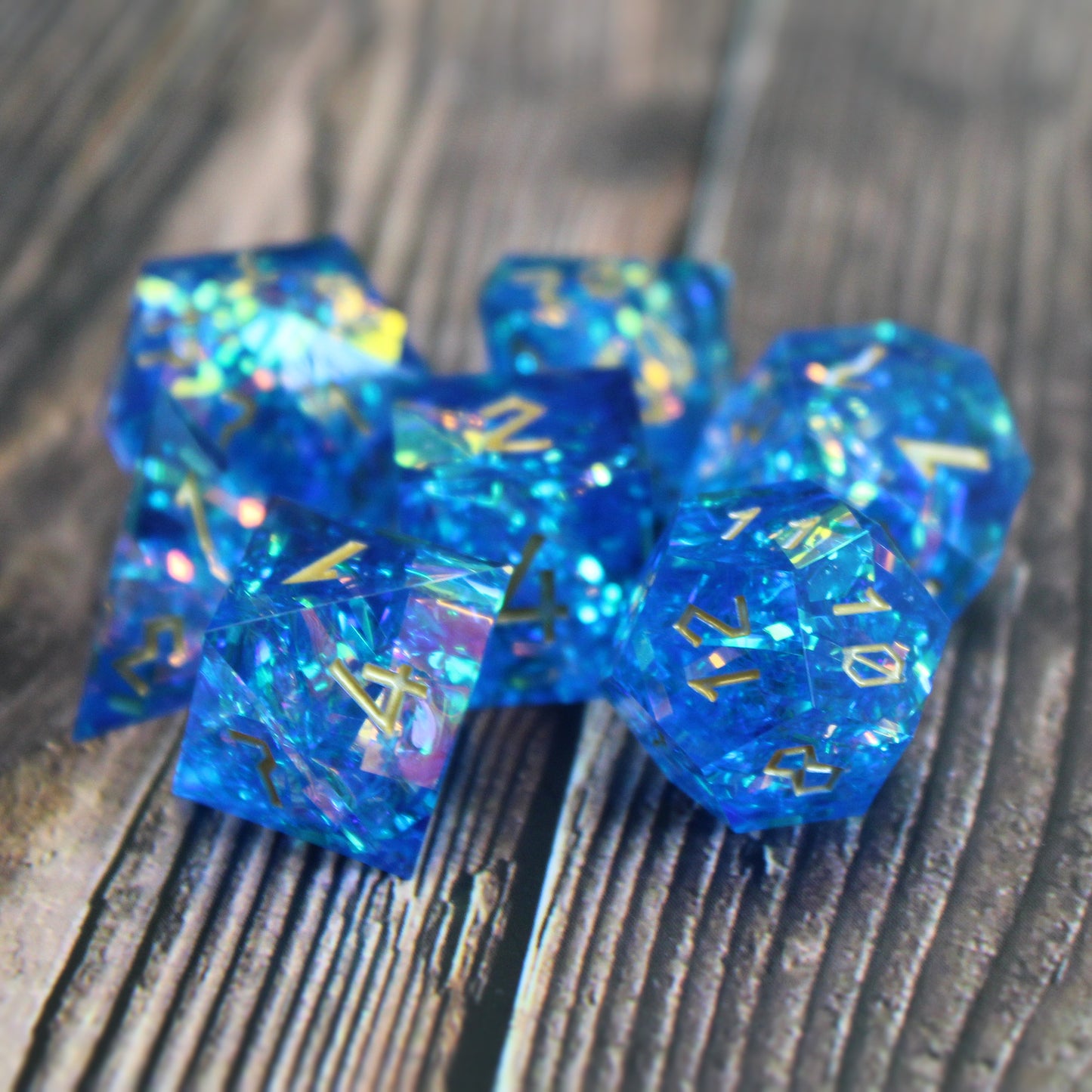 StarGlow Blue dice arranged in a pile on a wood surface.