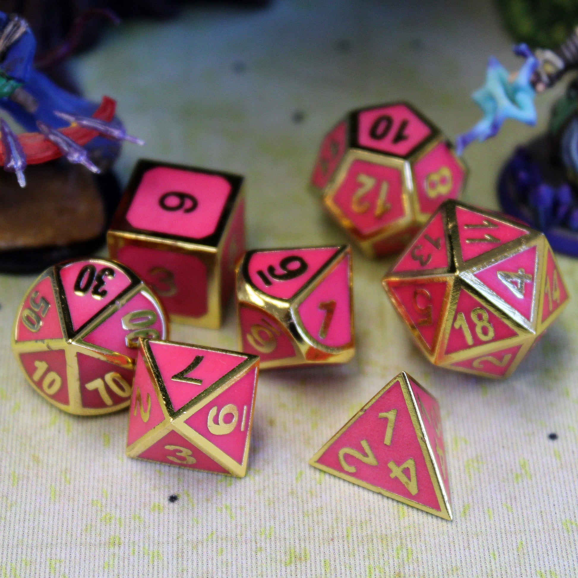 Imperial pink dice scattered on a printed map surface with two figurines on either side.