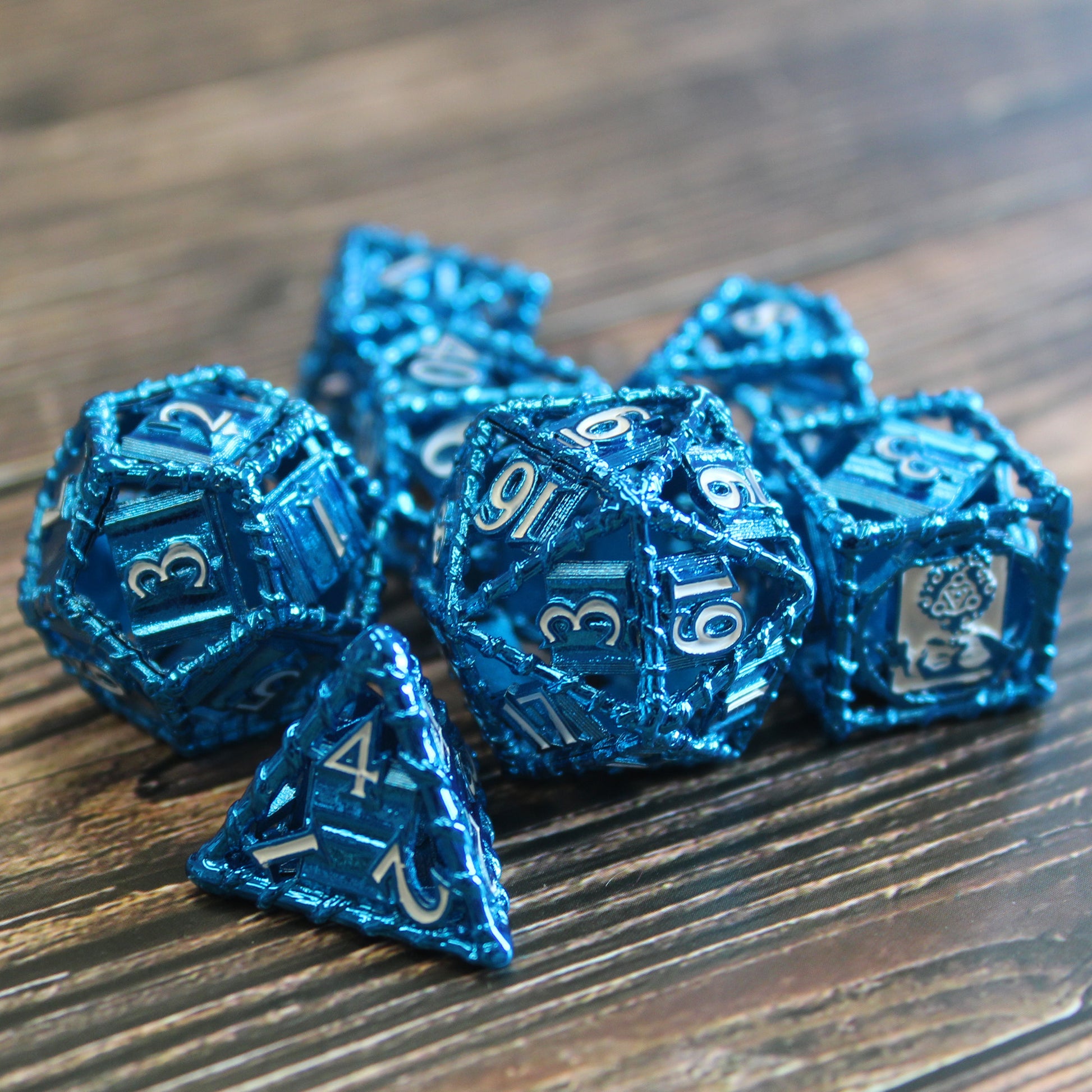 All 7 blue dice on wood paneled surface