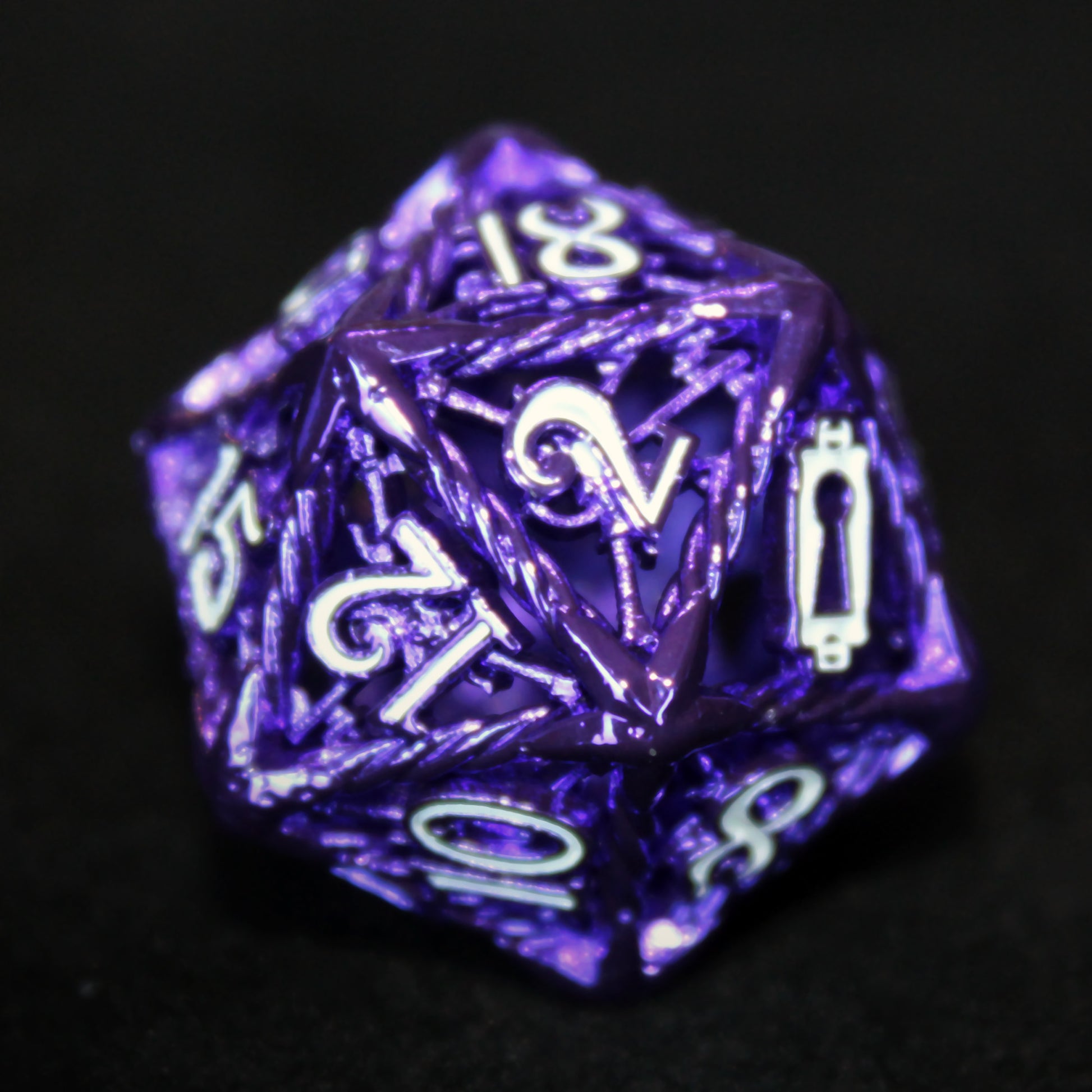 Close up of purple Rogue D20 on a black background. The shiny purple caging and white number inking is showcased.