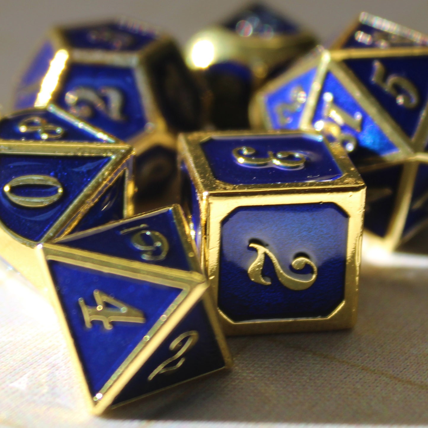 Close-up of the Imperial blue and gold dice set, showcasing the dark blue faces and gold numbers and framing.