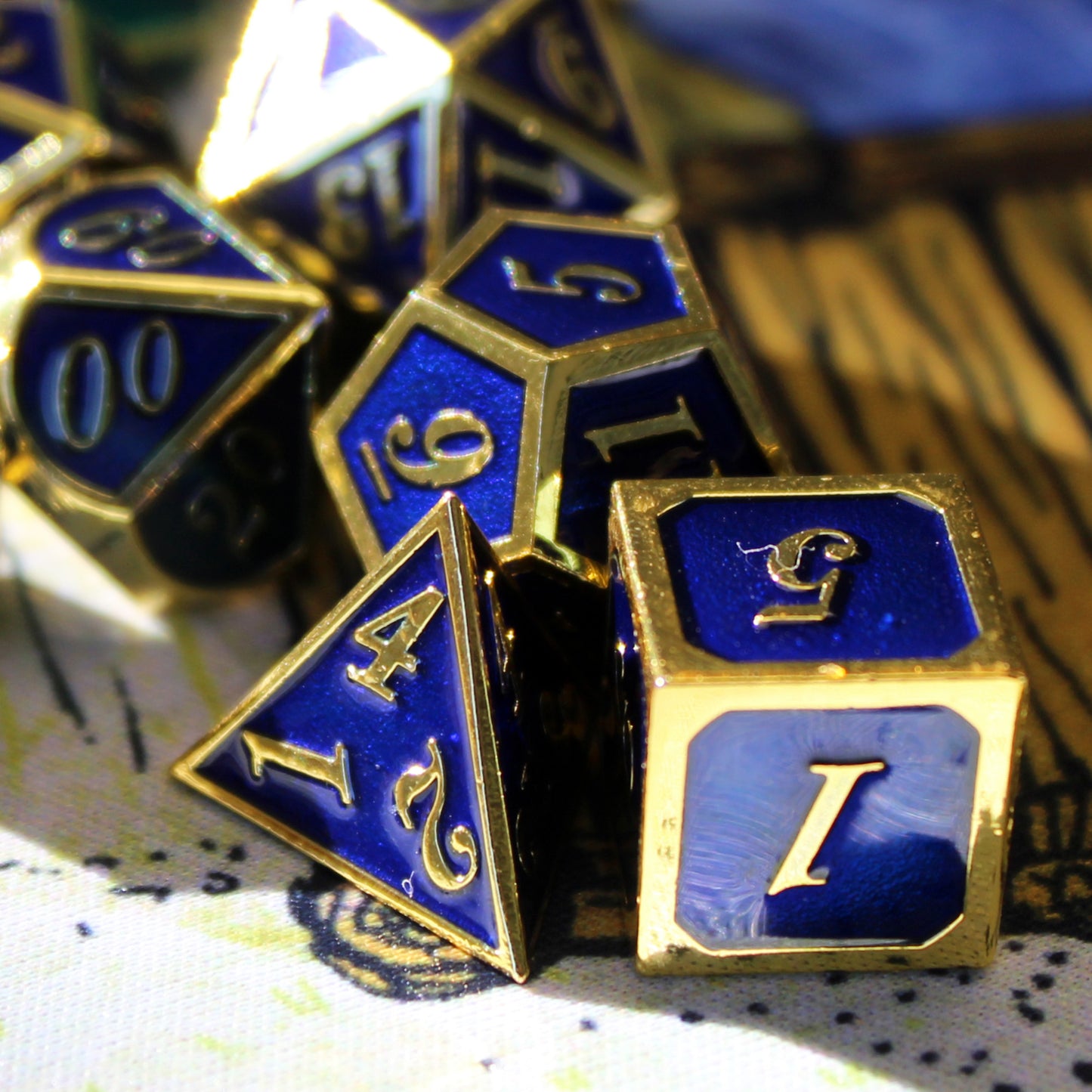 Imperial blue and gold dice set scattered on a play mat