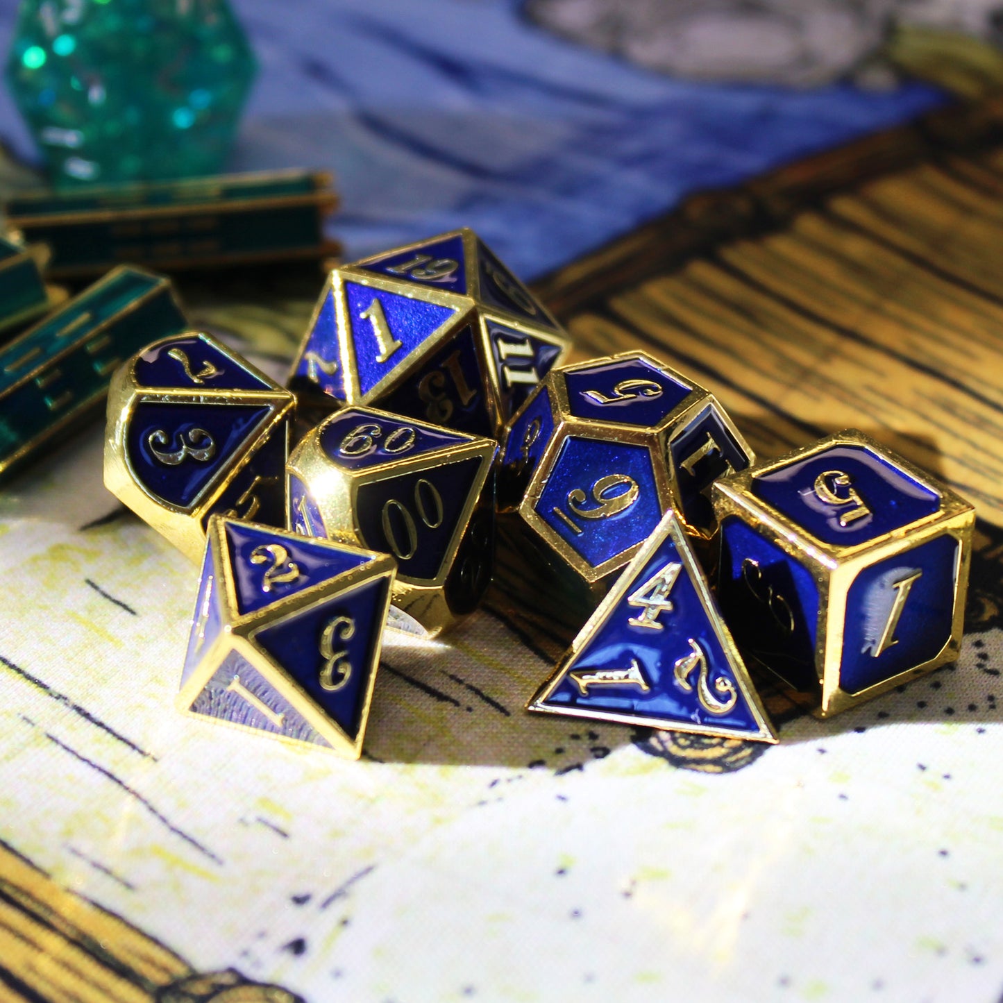 Imperial blue and gold dice set scattered on a play mat with other green set pieces scattered behind them.