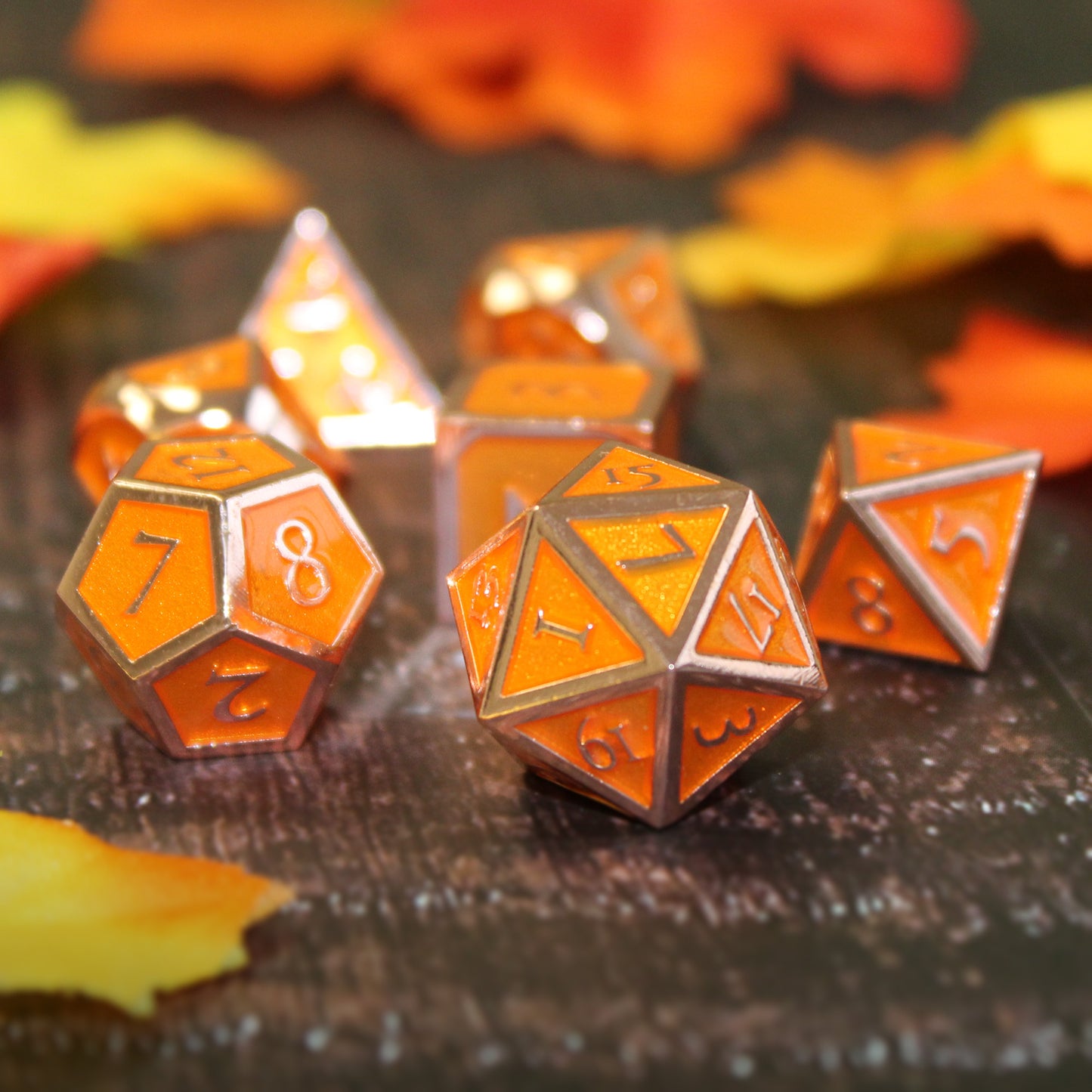 Imperial Pumpkin Spice dice scattered on a dark printed map surface with fabric leaves around them.