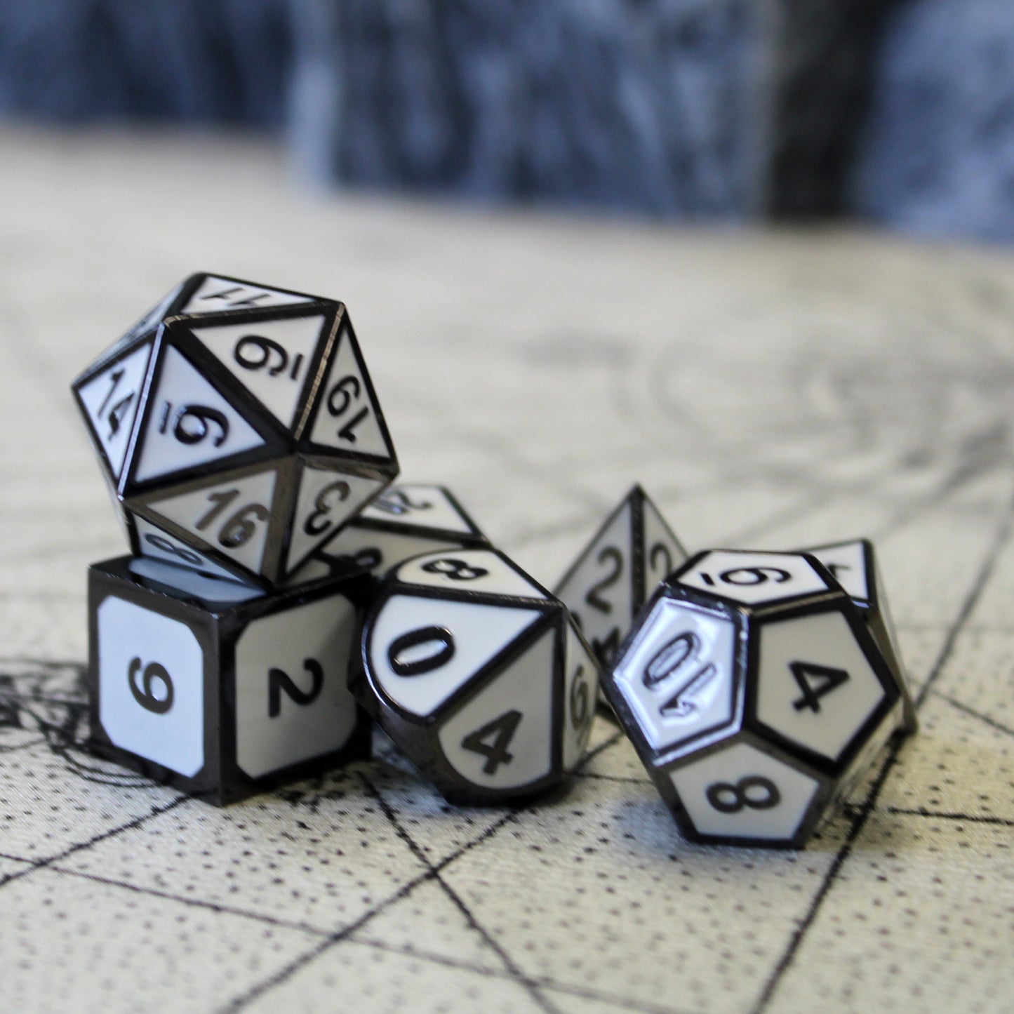 Imperial White dice set scattered on a tan play mat