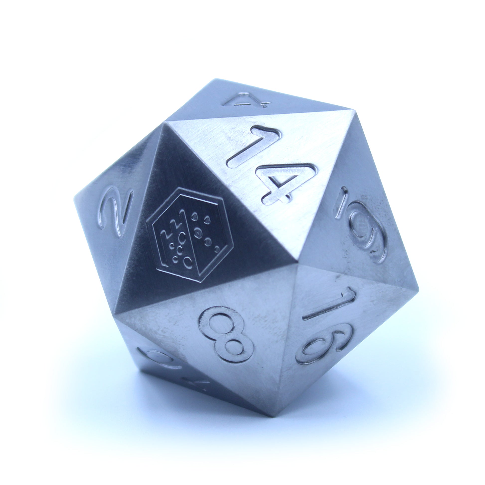 An oversized silver-colored metal twenty-sided die with a Dice Dungeons logo in place of the number twenty