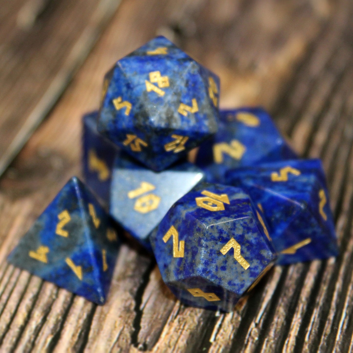 Lapis Lazuli dice set scattered on a wooden surface