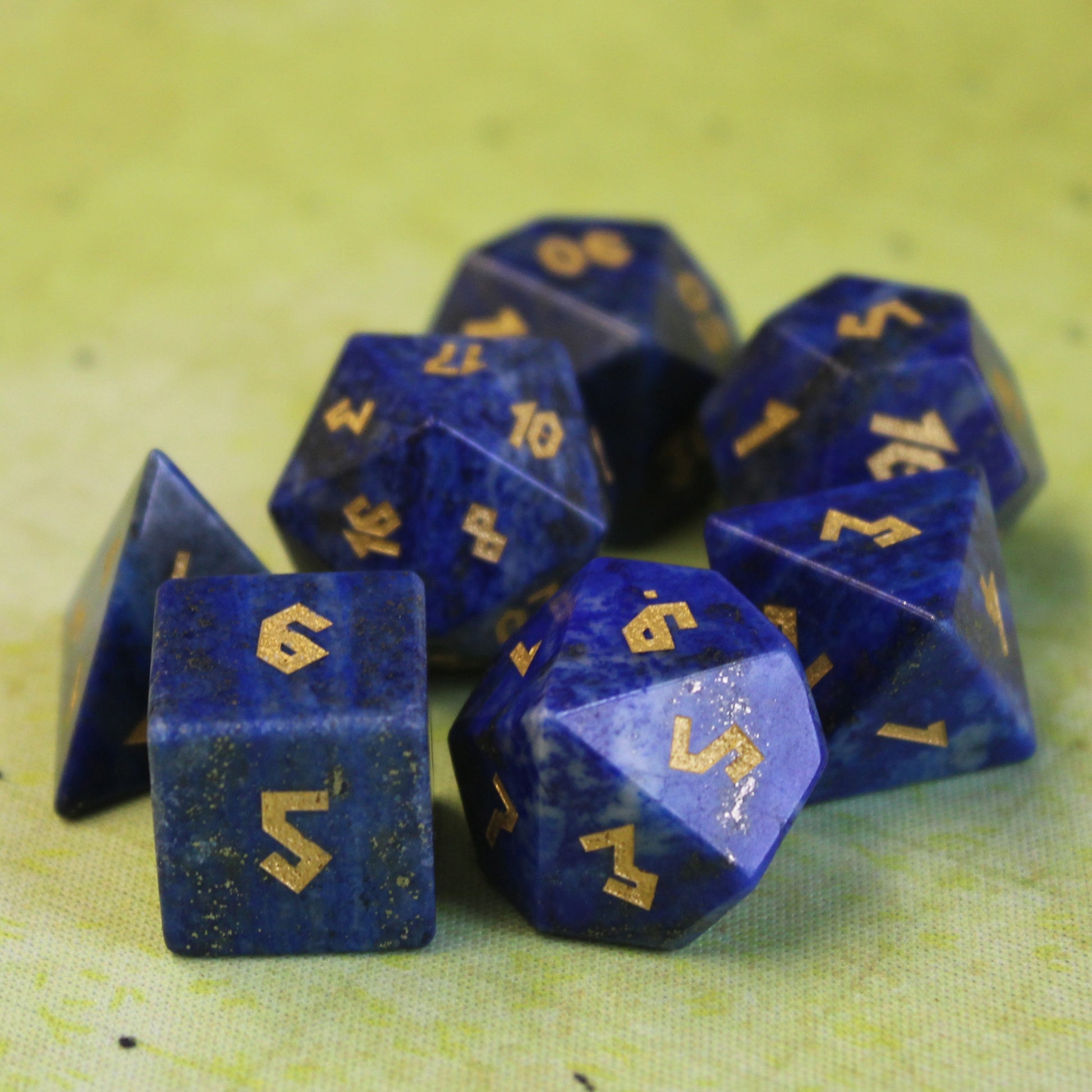 Lapis Lazuli dice set scattered on a green play mat