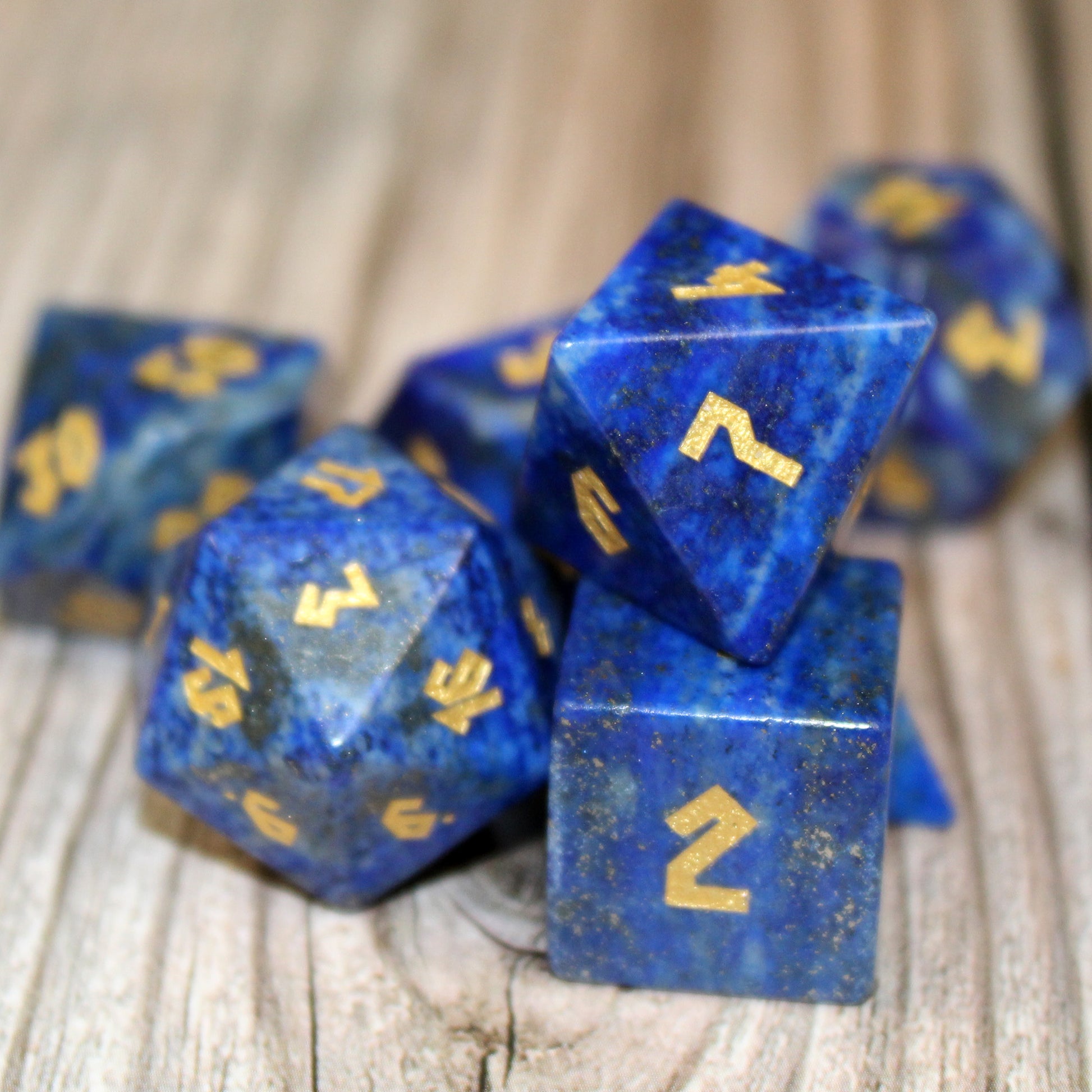 Lapis Lazuli dice set scattered on a wooden surface