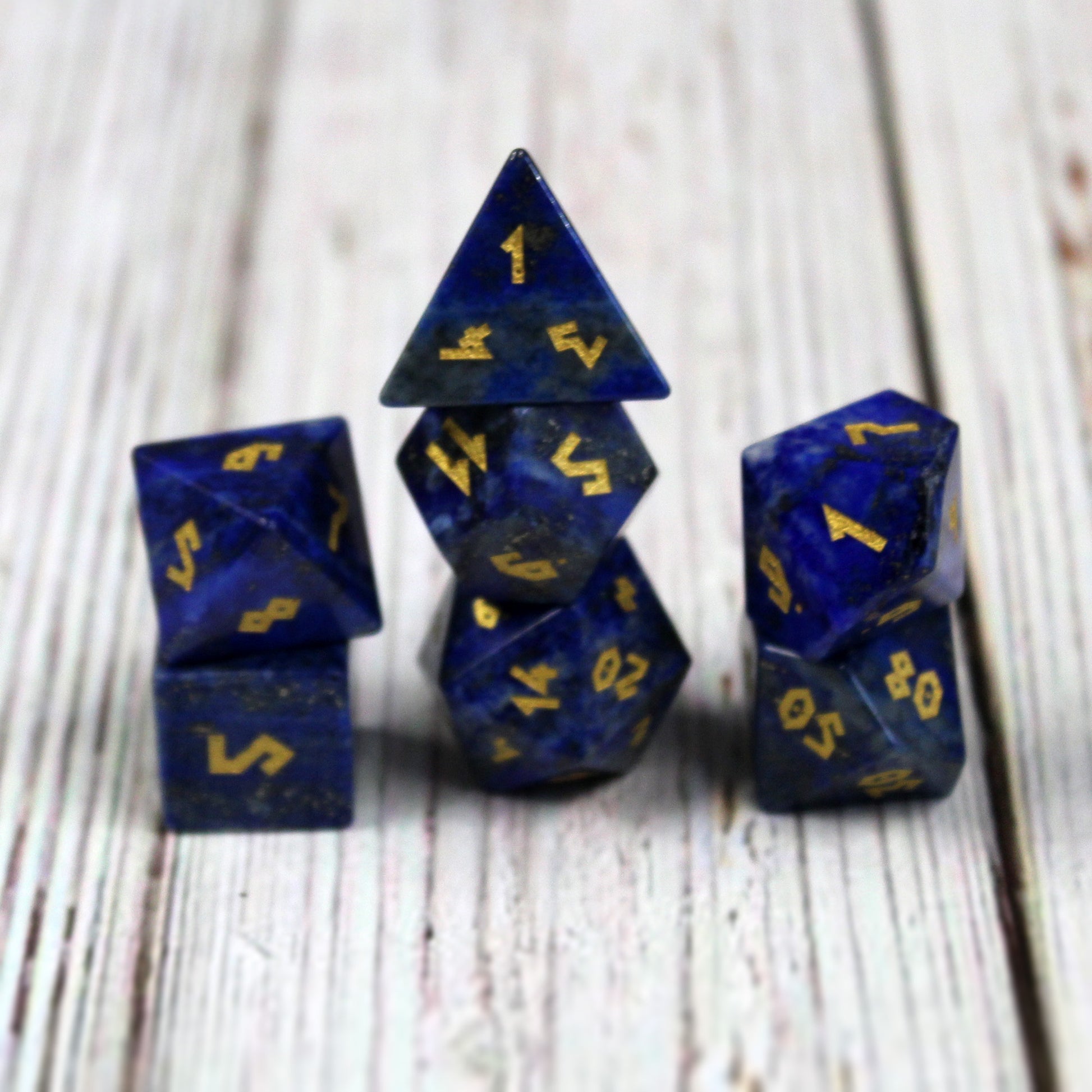 Lapis Lazuli arranged in three stacks on a wooden surface