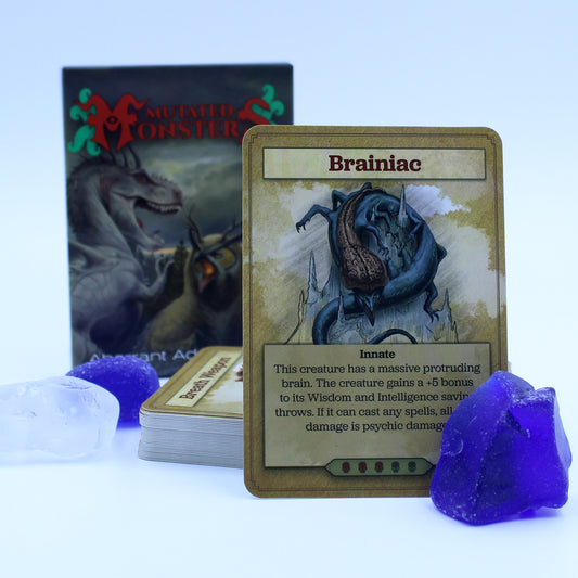 The deck box in the background with a stack of cards in the midground and a card propped up in the foreground. Cards are surrounded by a few blue and white stones. All on a white background.