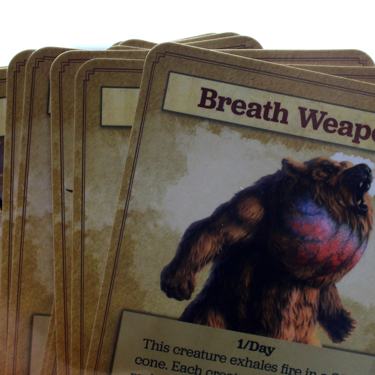 Up close image of a stack of cards, displaying the top left edge and background coloring of each card