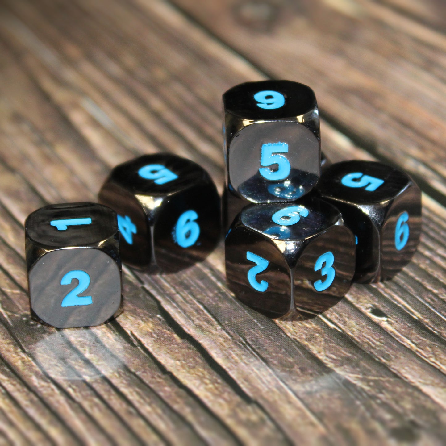 Six Black Frost D6 dice scattered on a wooden surface