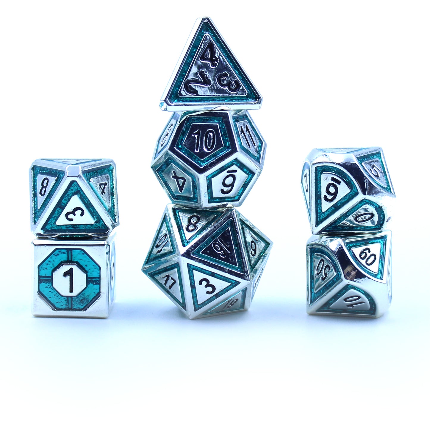 Photograph of stacked silver gaming dice with teal inlays in a bullseye pattern on a white background.