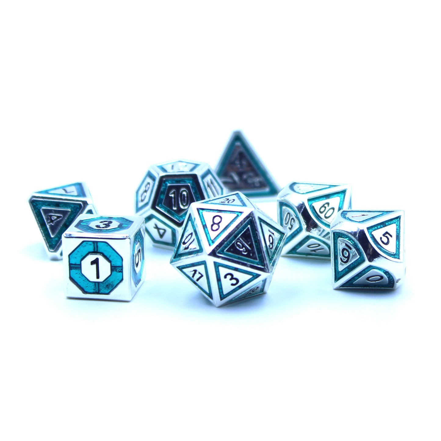 Photo of silver dice with bullseye-shaped teal inlays on a white background.