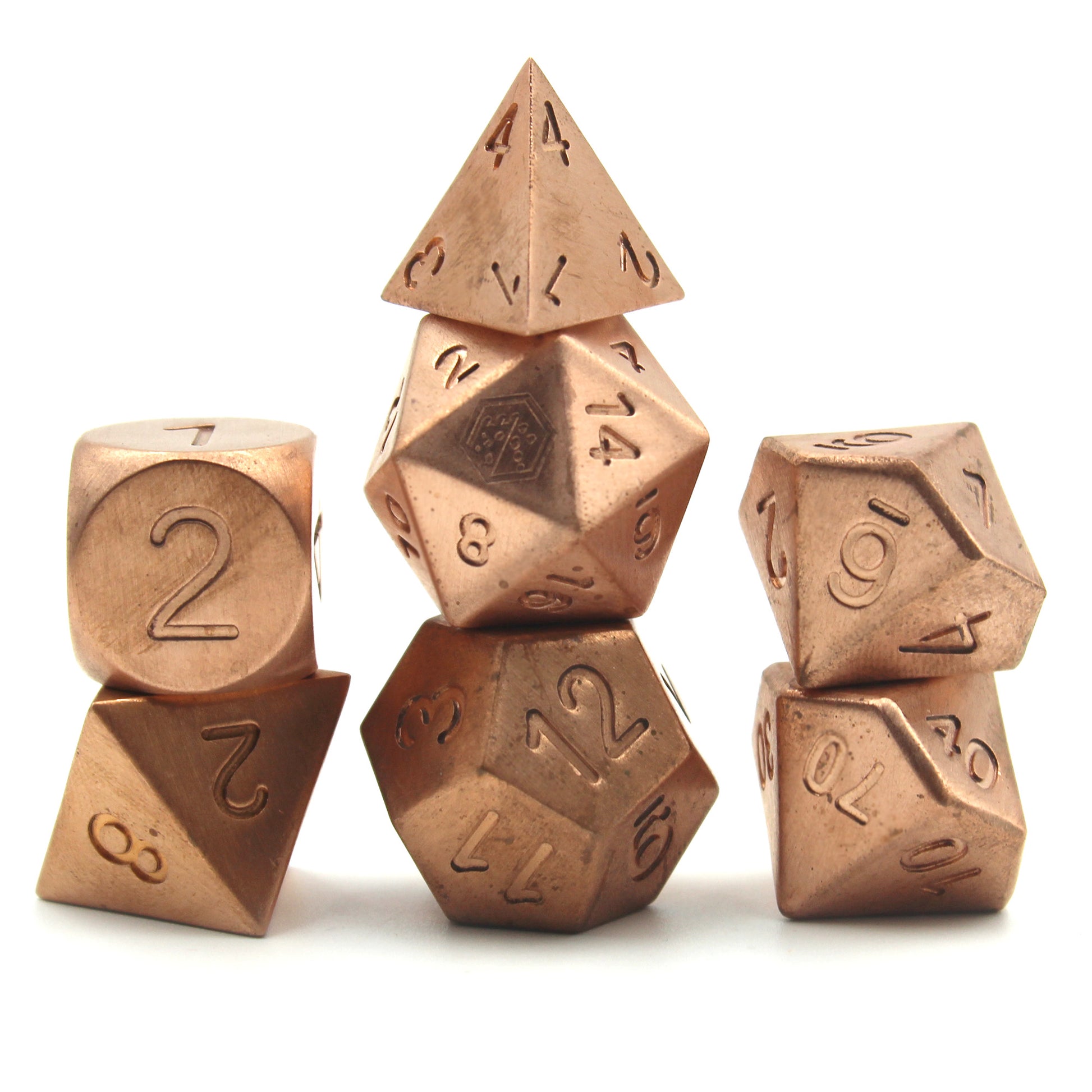 Metal Copper dice set arranged in 3 columns on a white surface and background.