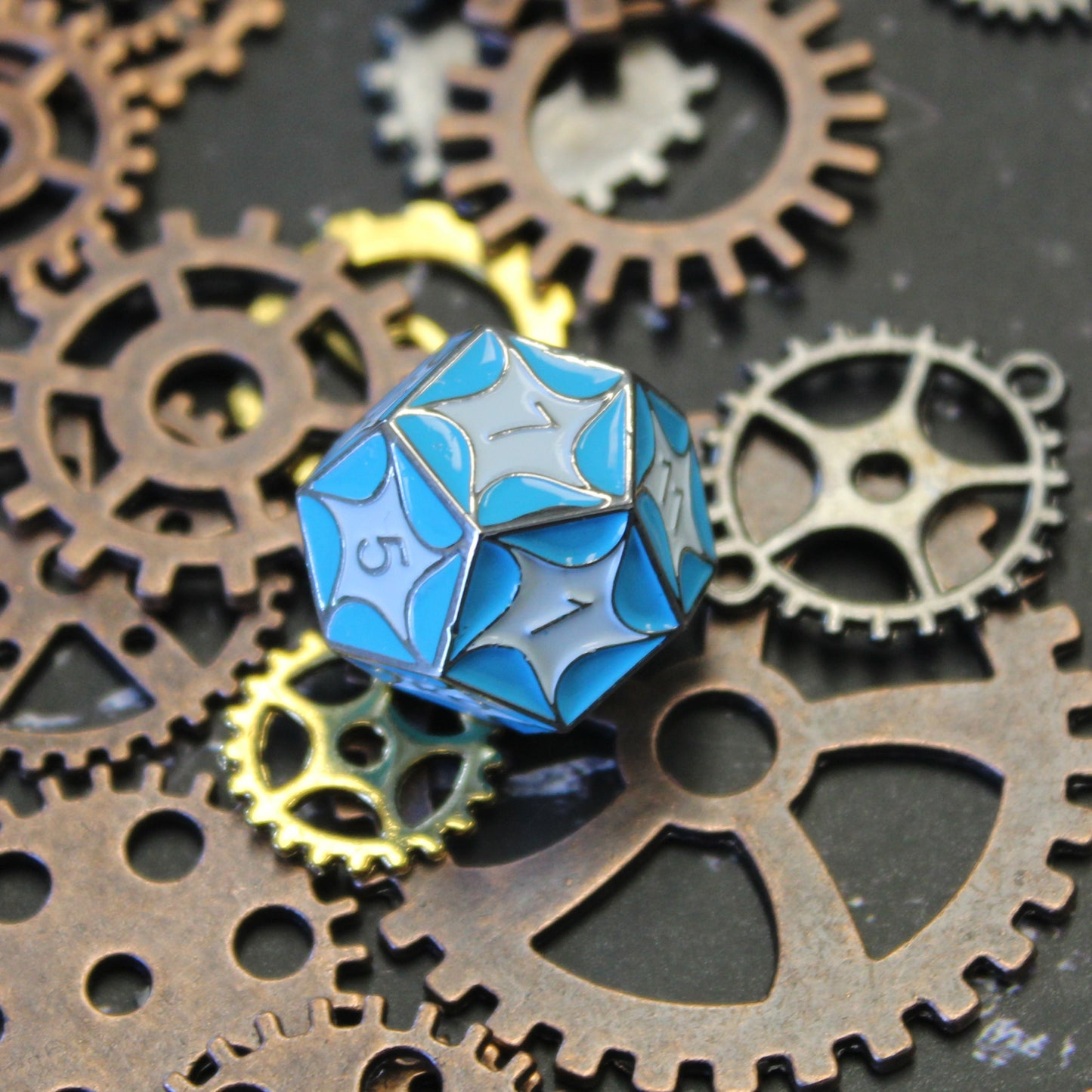 D12 die with blue dragon scales and gears in the background for RPG enthusiasts.