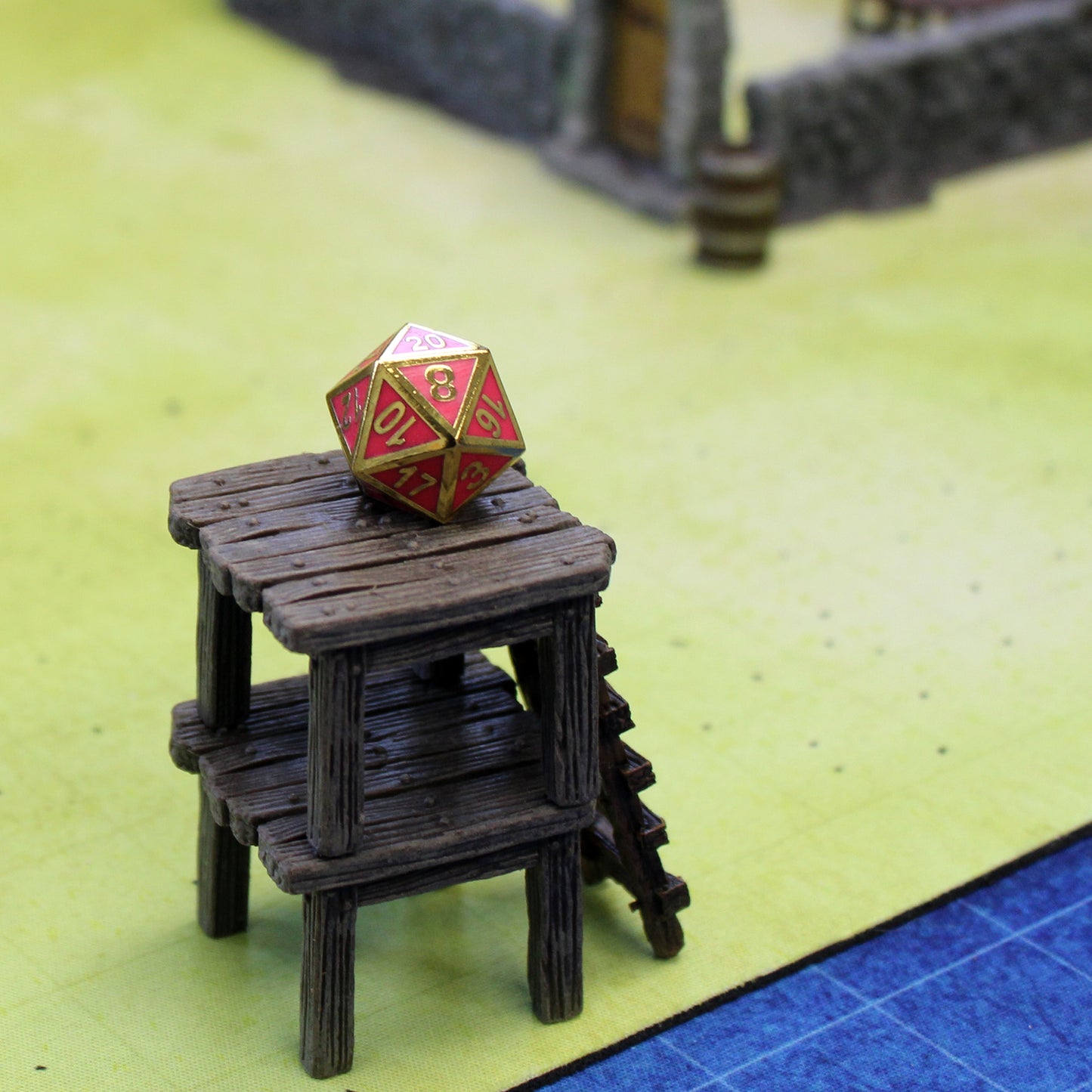The pink imperial dice set D20  on a raised wooden set piece on top of a printed map.
