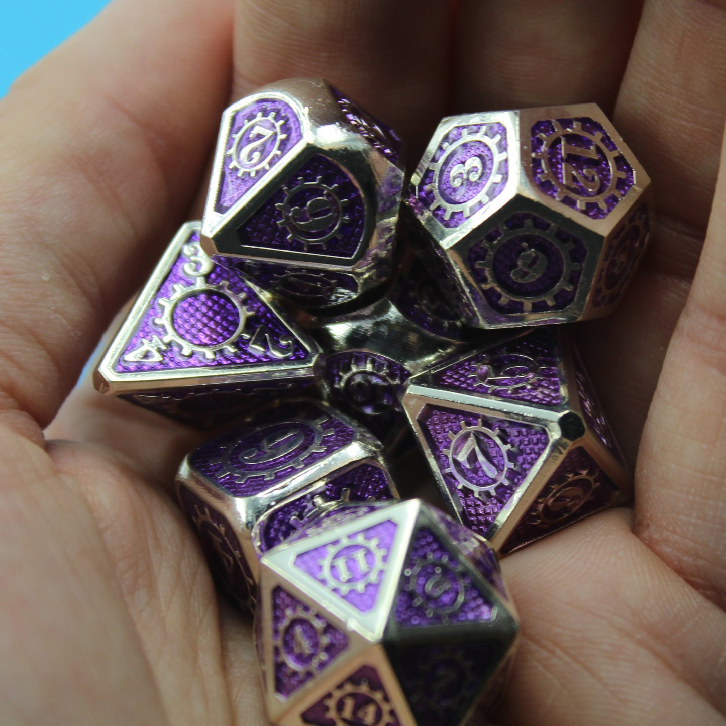 Mechanist dice set arranged in a pile in the palm of someone's hand.