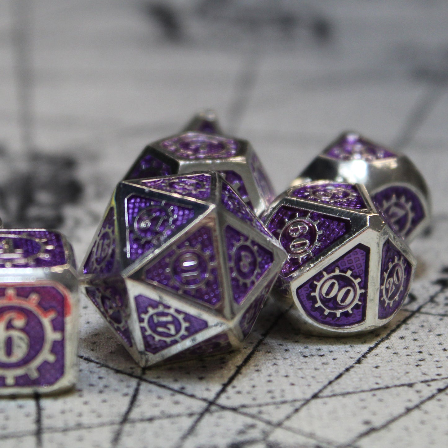 A closeup of some of the Mechanist dice in the set arranged on a white game mat.