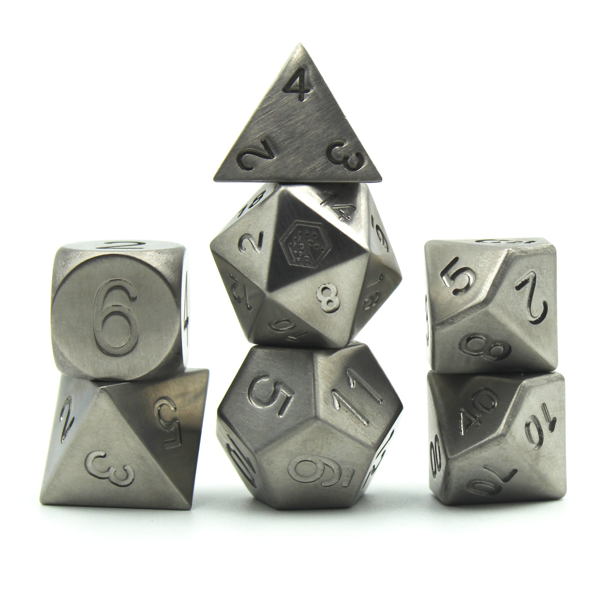 Metal Titanium dice set arranged in 3 columns on a white background and surface.  The 20 face of the d20 shows the Dice Dungeon logo instead of the numeral 20.  The dice are uniformly gray in color and the numbers do not have inking.