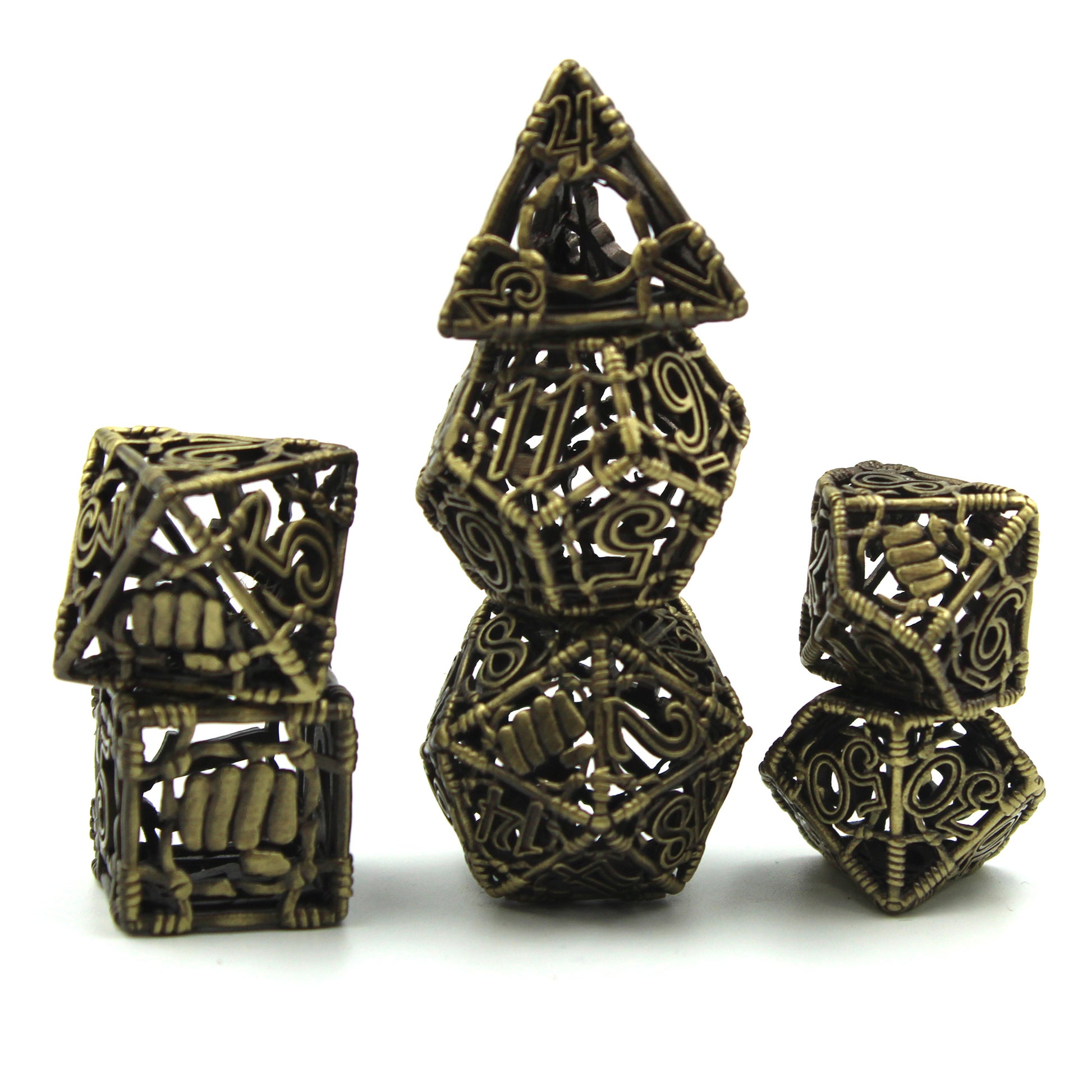 All 7 brass dice piled up in 3 stacks. Two dice in first stack, three dice in second stack, two dice in third stack. All on a white background.