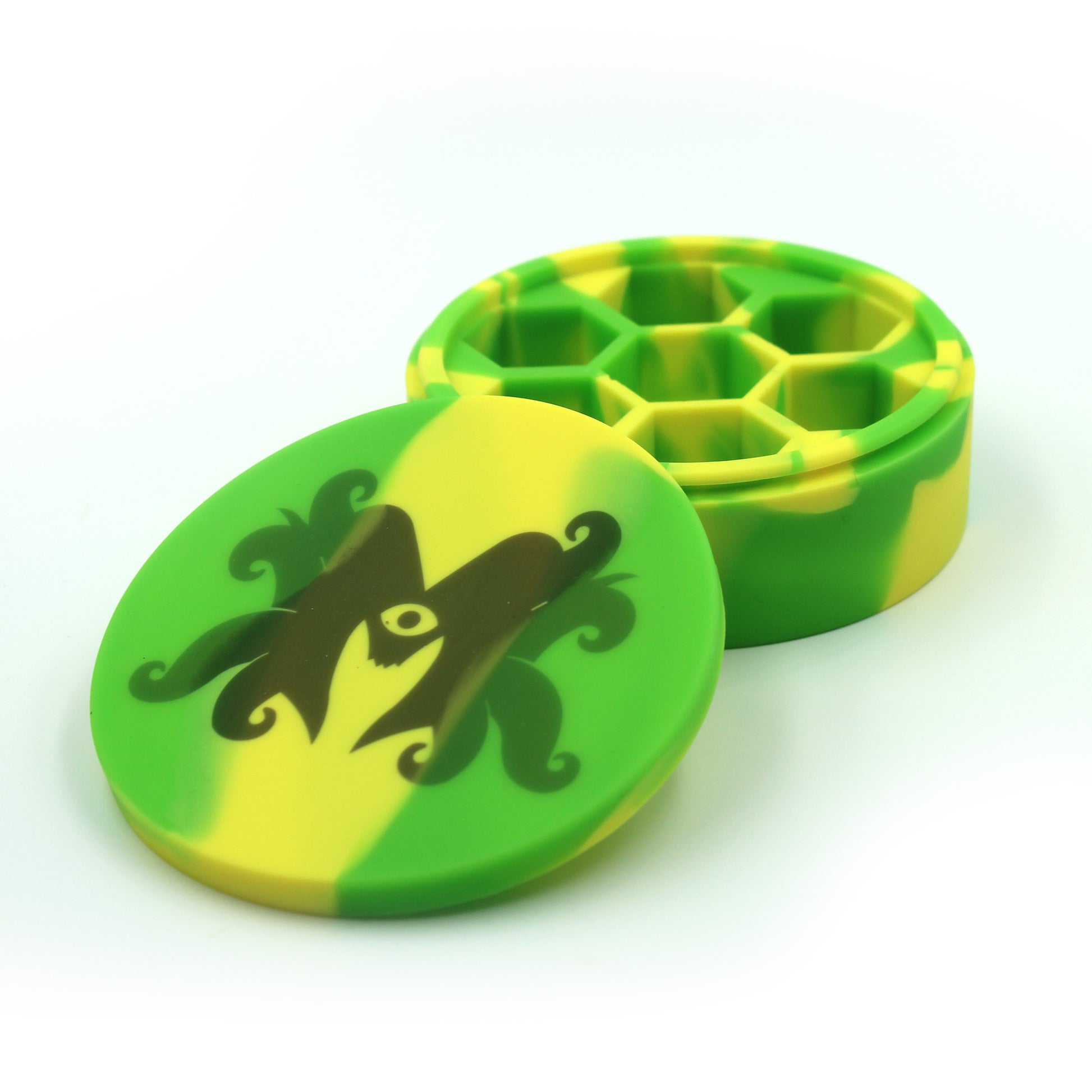 silicone case is on white background with lid open so that all 7 dice indentations can be seen inside. Lid of case is propped up on bottom. Image on top of case is mutated monsters logo. Case has a lime green and yellow tie-dye effect. On a white background.