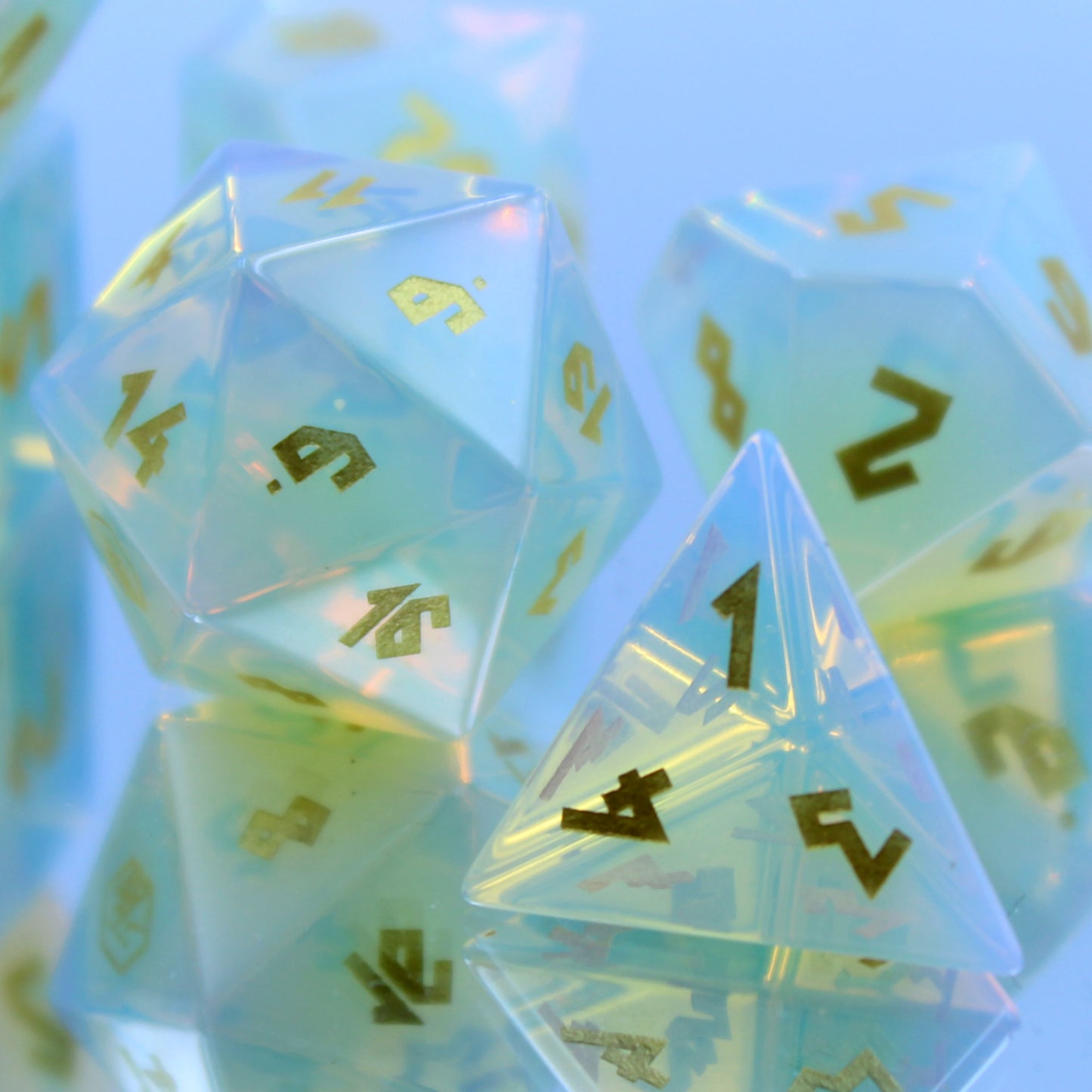 Opalite dice set on mirror, zoomed in on D20 and D4, natural light refracting vibrant colors for an enchanting DnD experience.