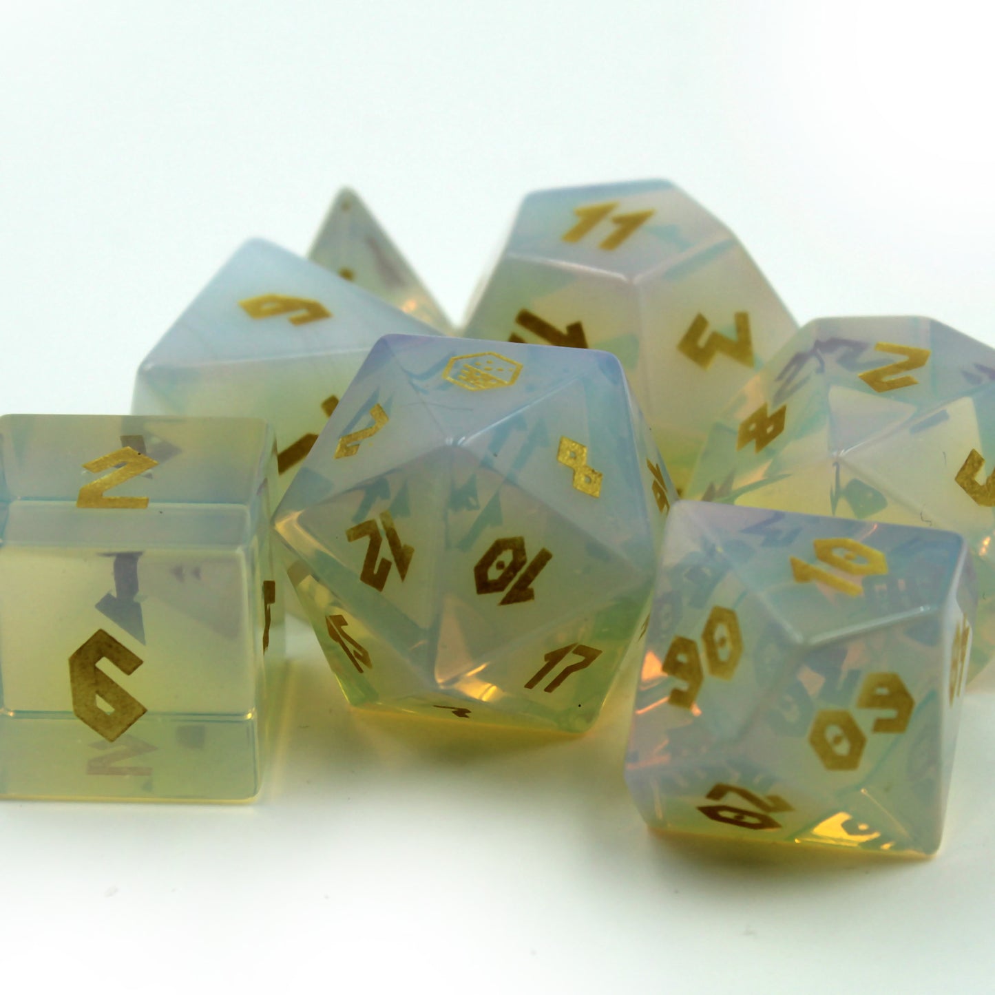 Dice set on white background under bright light, appearing to glow from within, adding luck to your DnD sessions.