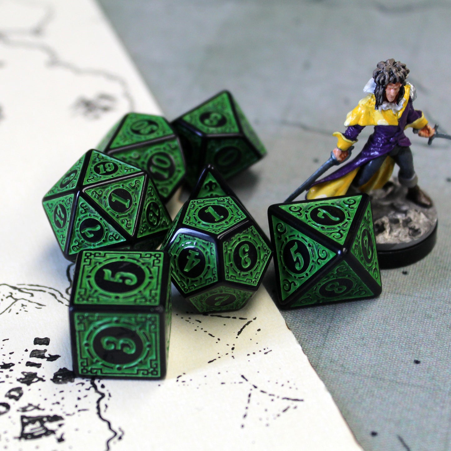 Oracle's Flame green dice set arranged on top of a white and gray game map. A mini figure is to the right of the dice set.