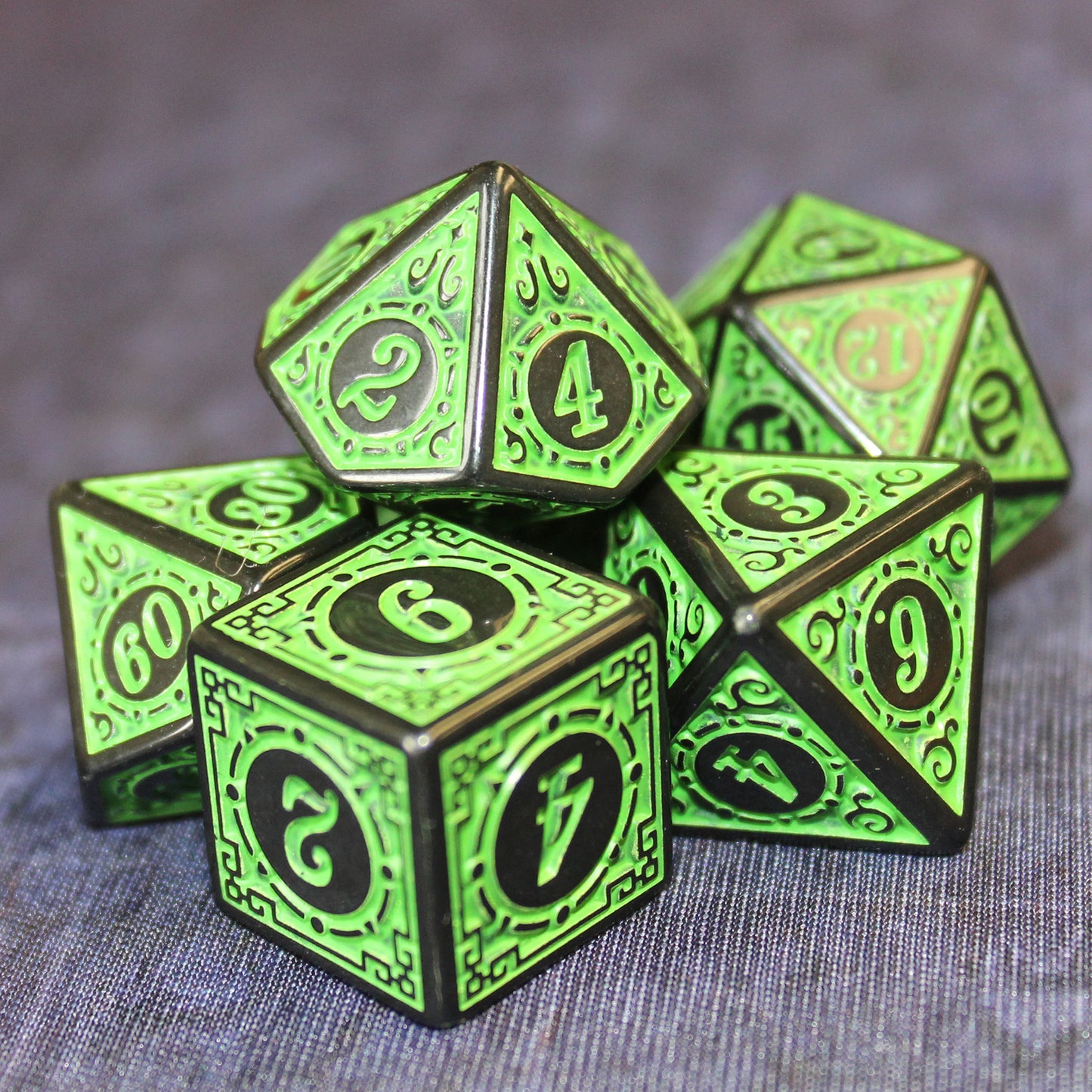 Oracle's Flame green dice set arranged in a pile on top of a gray cloth.