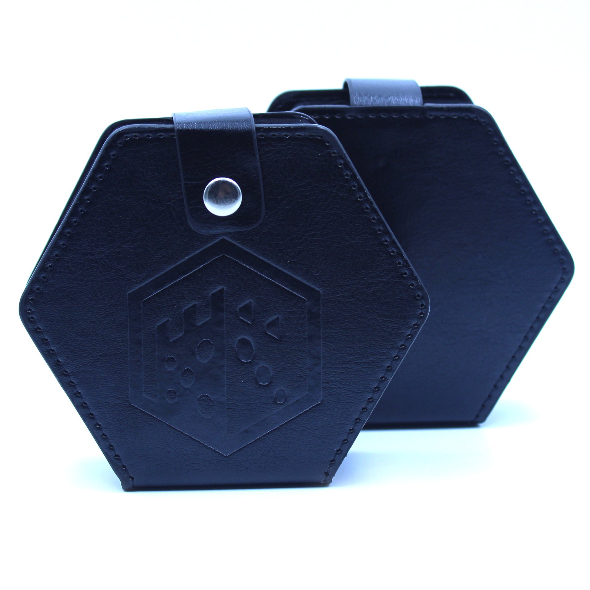 Two black faux leather hexagonal dices case with a silver snap enclosure and the Dice Dungeons logo embossed onto the front of them