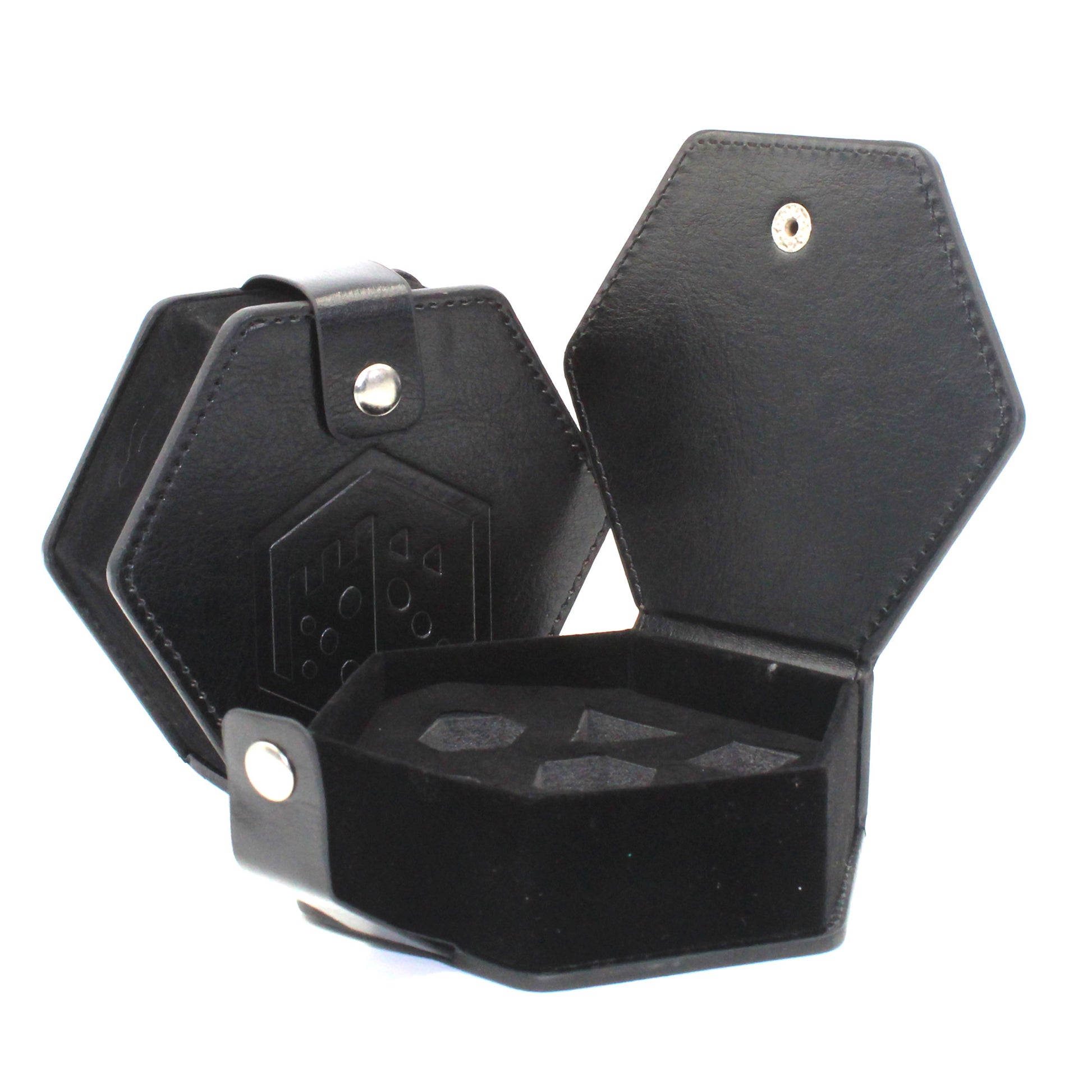 Two black faux leather hexagonal dice cases with a silver snap enclosure and the Dice Dungeons logo embossed onto the front of them, one opened showing the empty slots for dice to fit into.