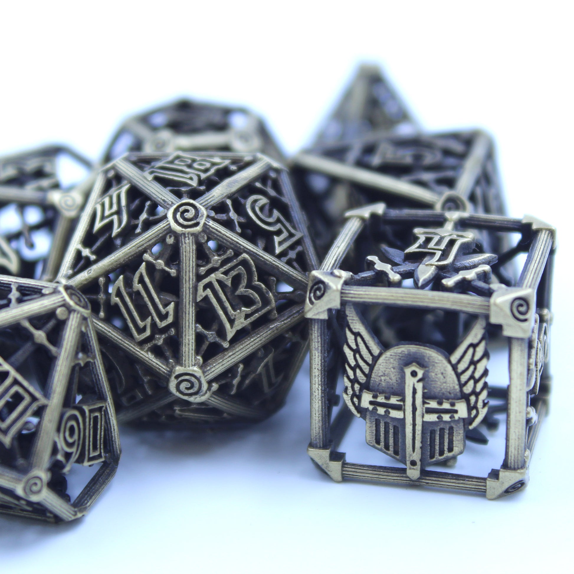 Up close of 6 sided and 20 sided dice, with other dice partially in frame, blurred in background. All on a white background.