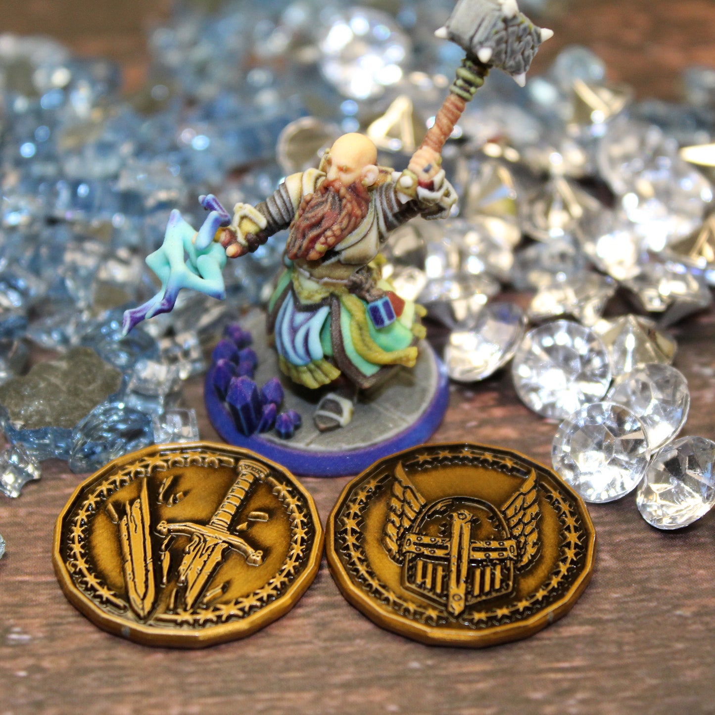 Antique gold finished Paladin Character coins arranged around a miniature on a printed map surface with sea glass in the background. These coins are sized for a 1 inch battle map.