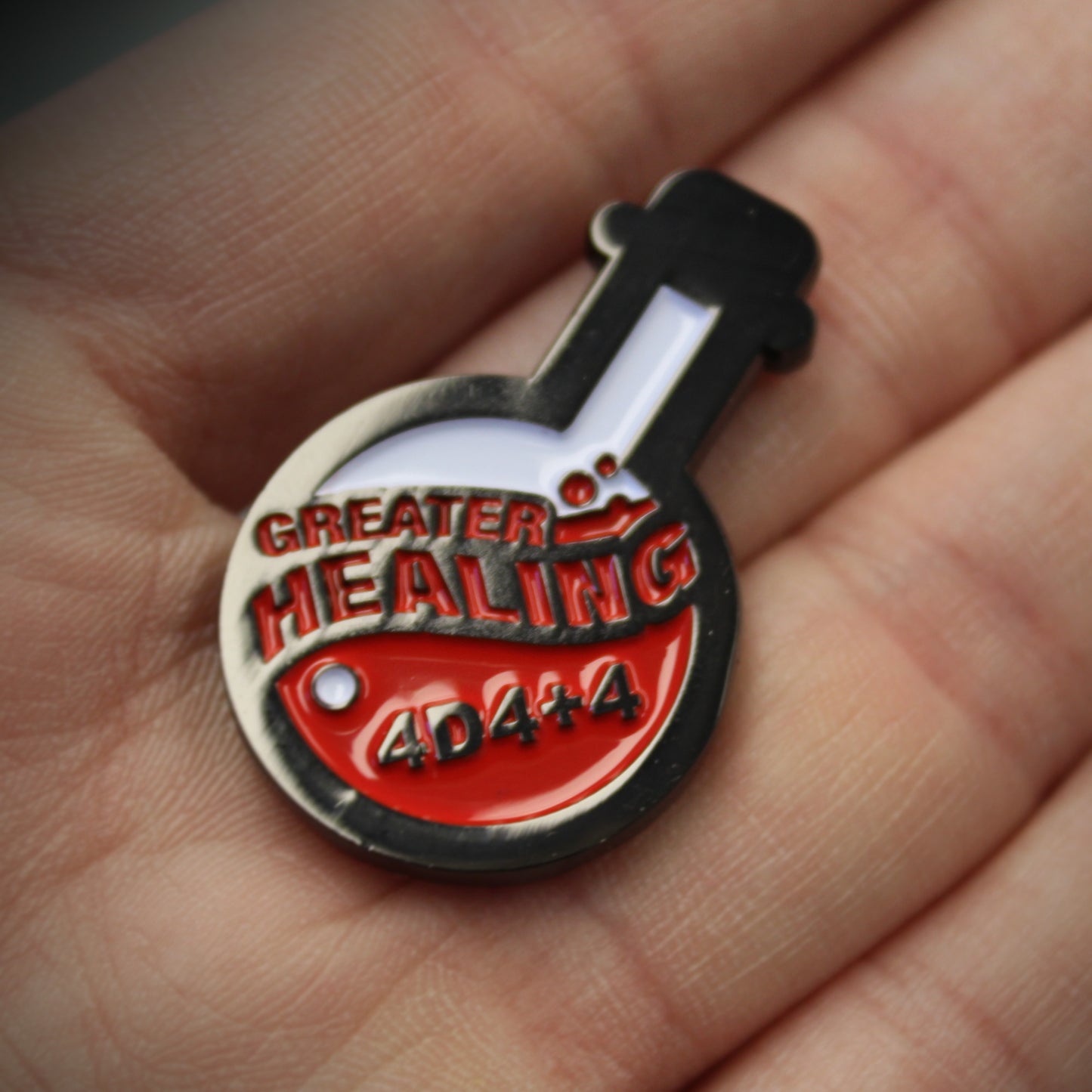 A closeup of the Potion of Greater Healing token in the palm of someone's hand